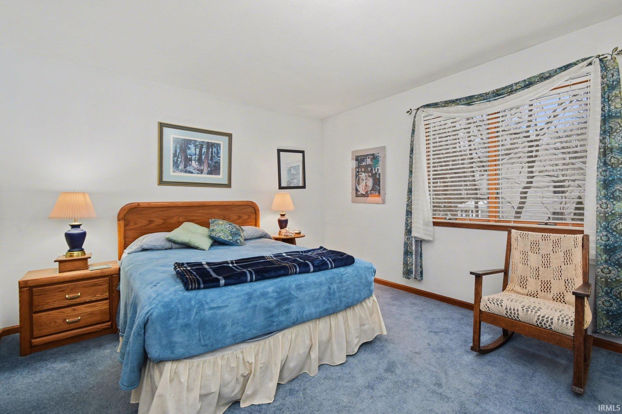 Bedroom with carpet floors and baseboards