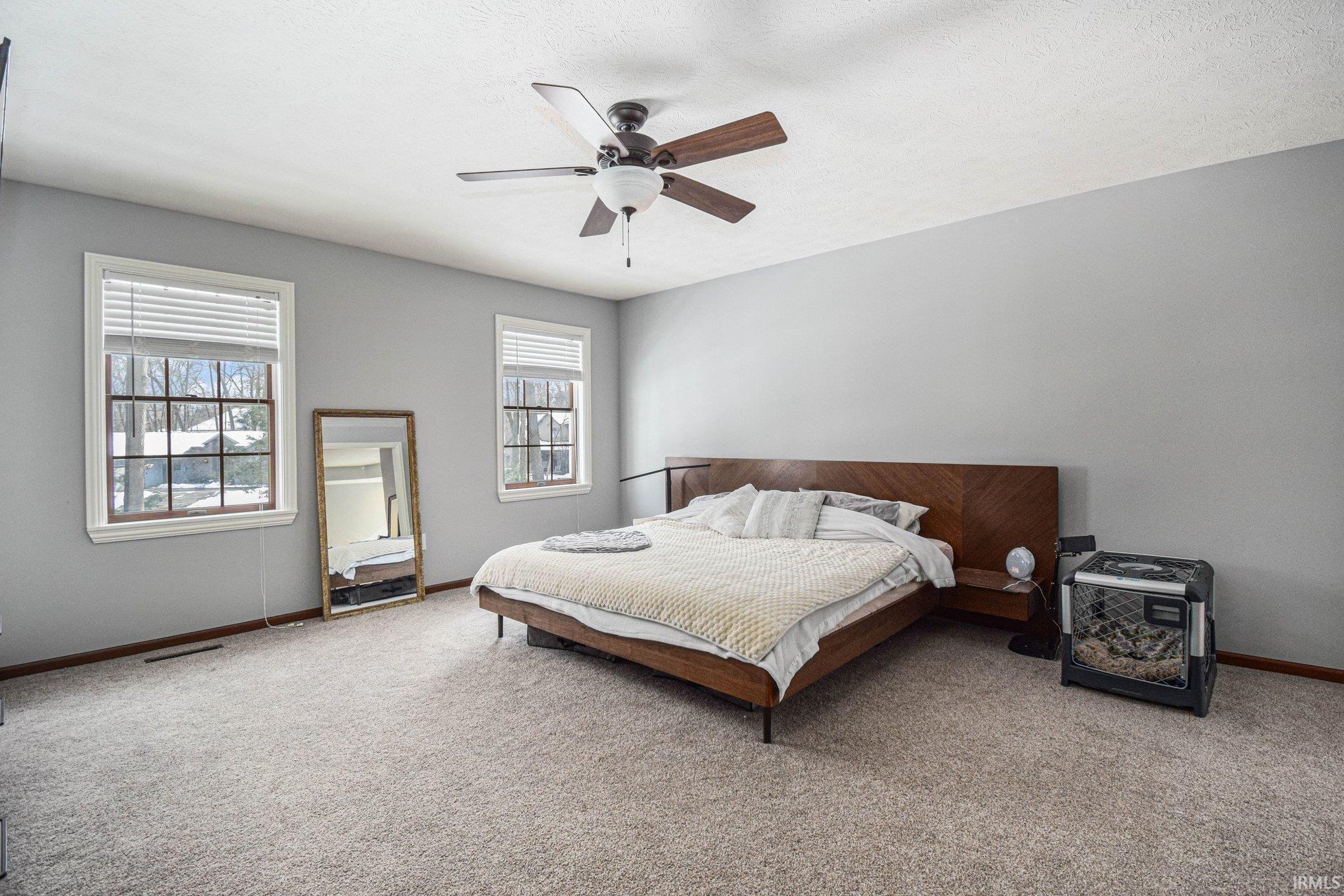Bedroom with carpet flooring and ceiling fan