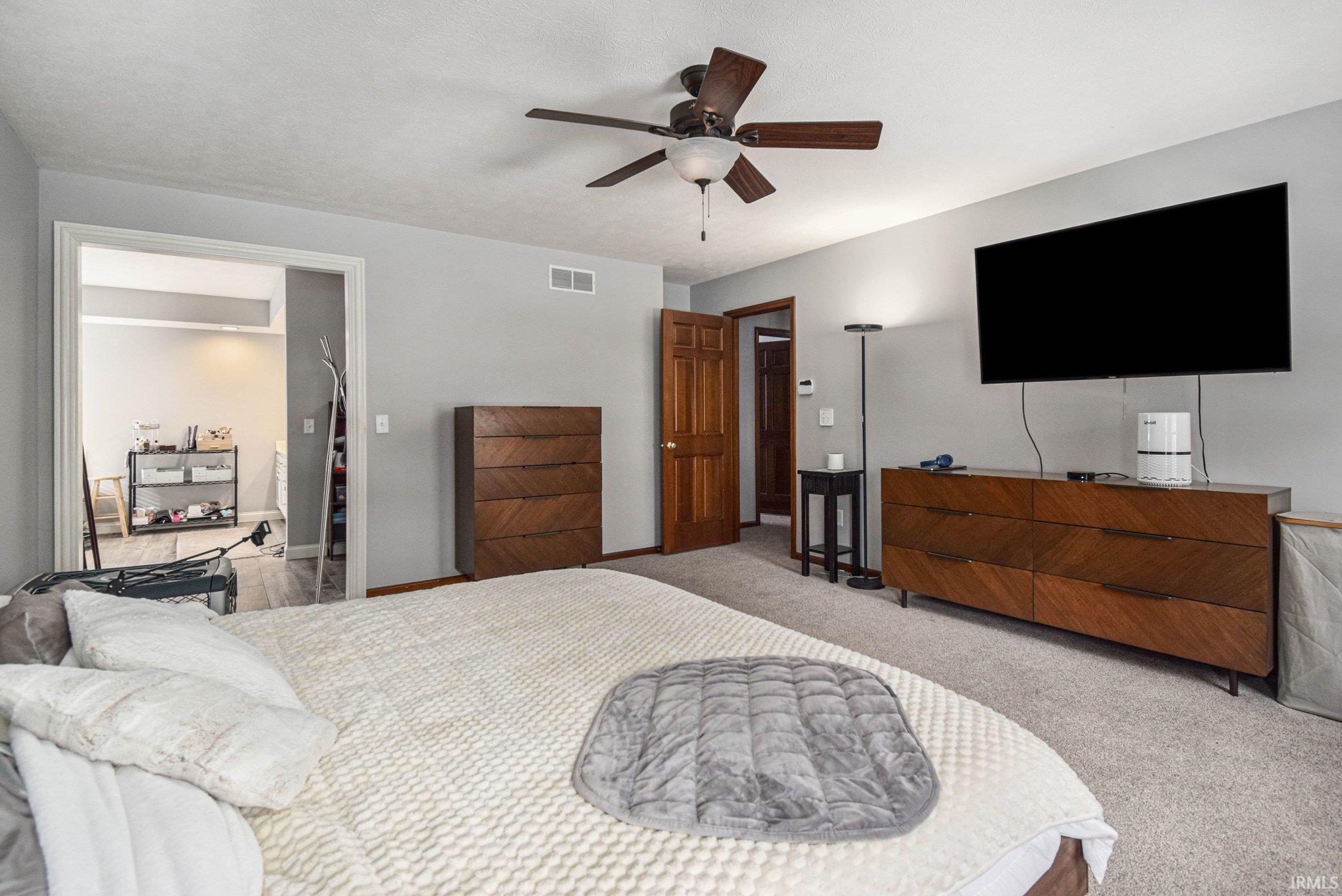 Bedroom featuring light carpet and a ceiling fan