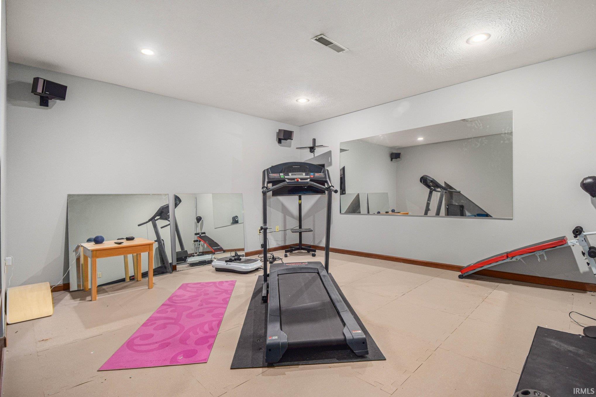 Exercise area featuring baseboards and recessed lighting