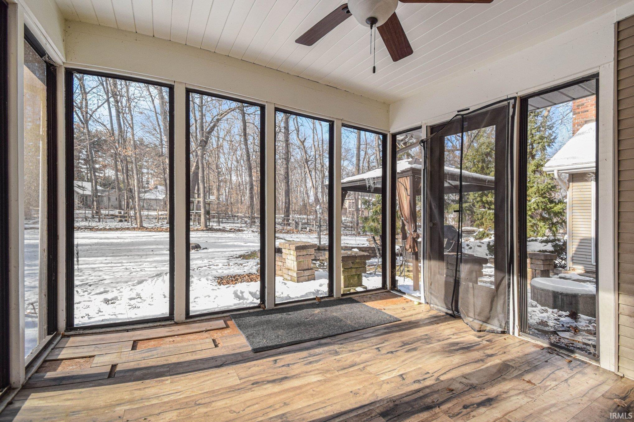 Unfurnished sunroom with wood-type flooring and wood ceiling