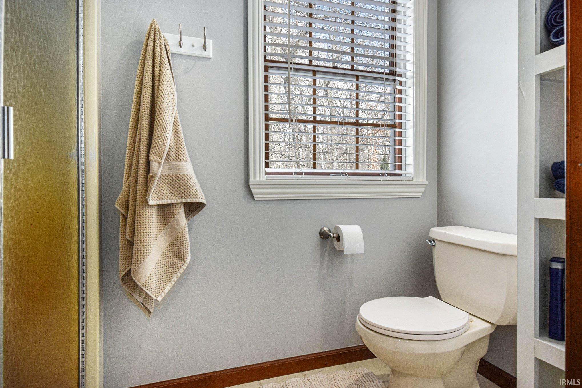 Bathroom with toilet and baseboards