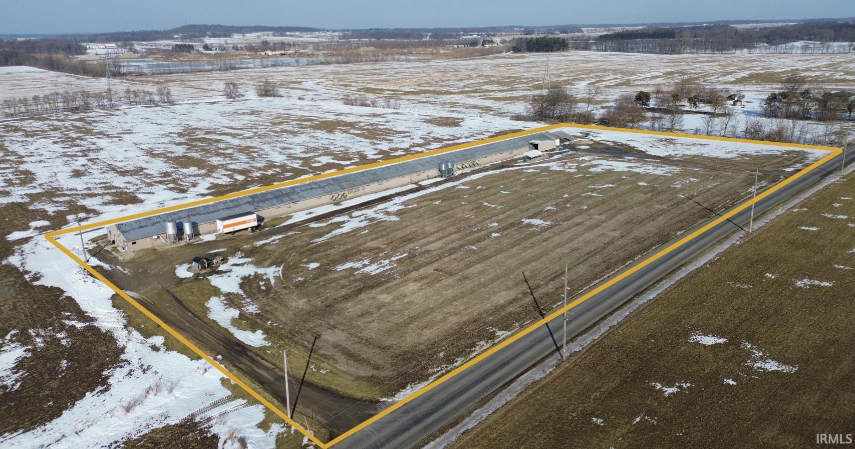 Snowy aerial view with property parcel outlined