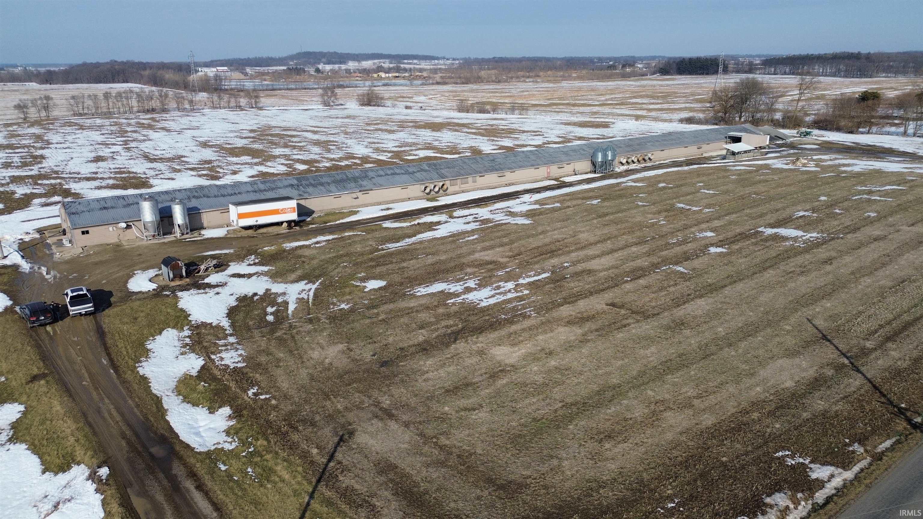 Snowy aerial view featuring a view of rural / pastoral area