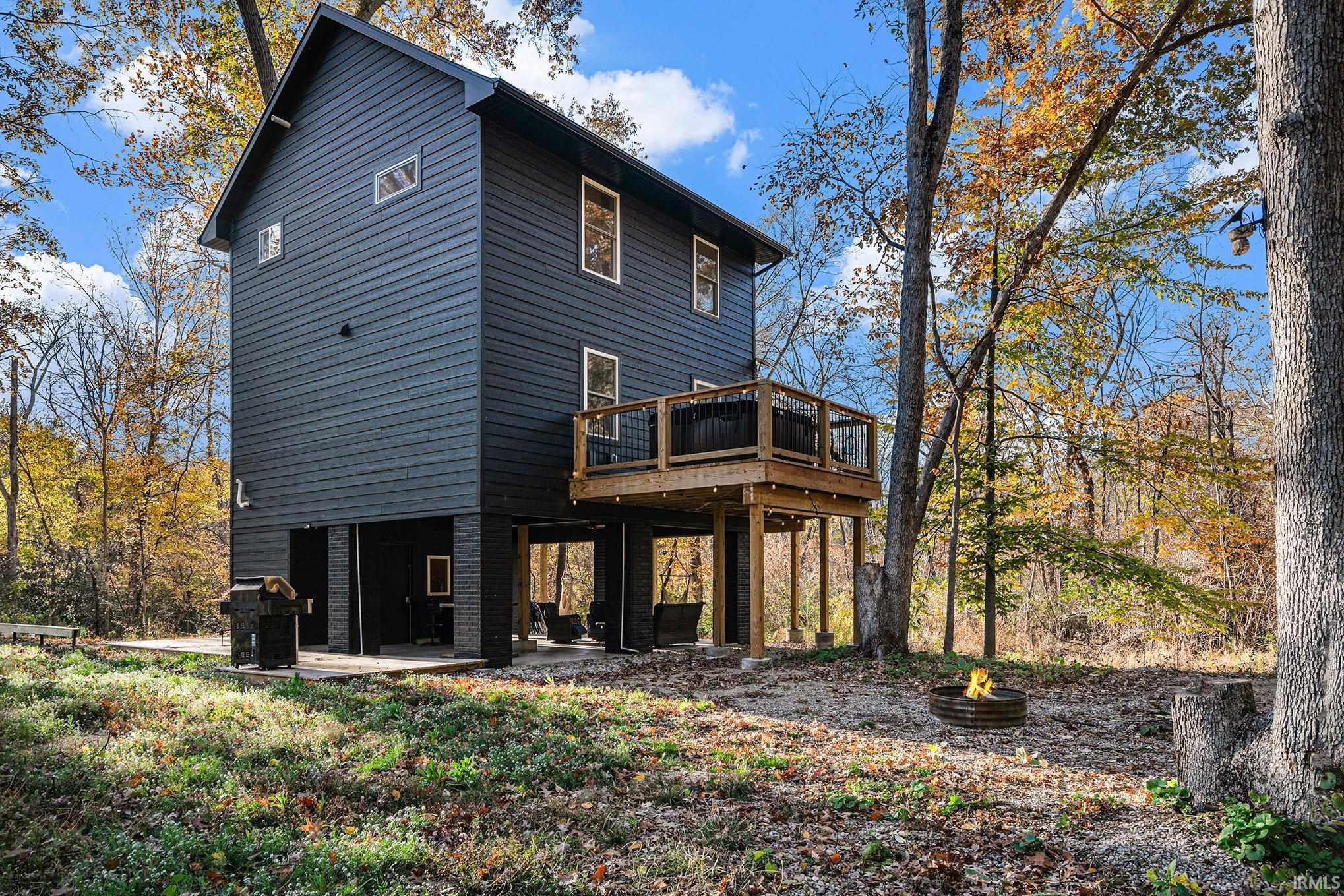 Back of property with a deck and a patio