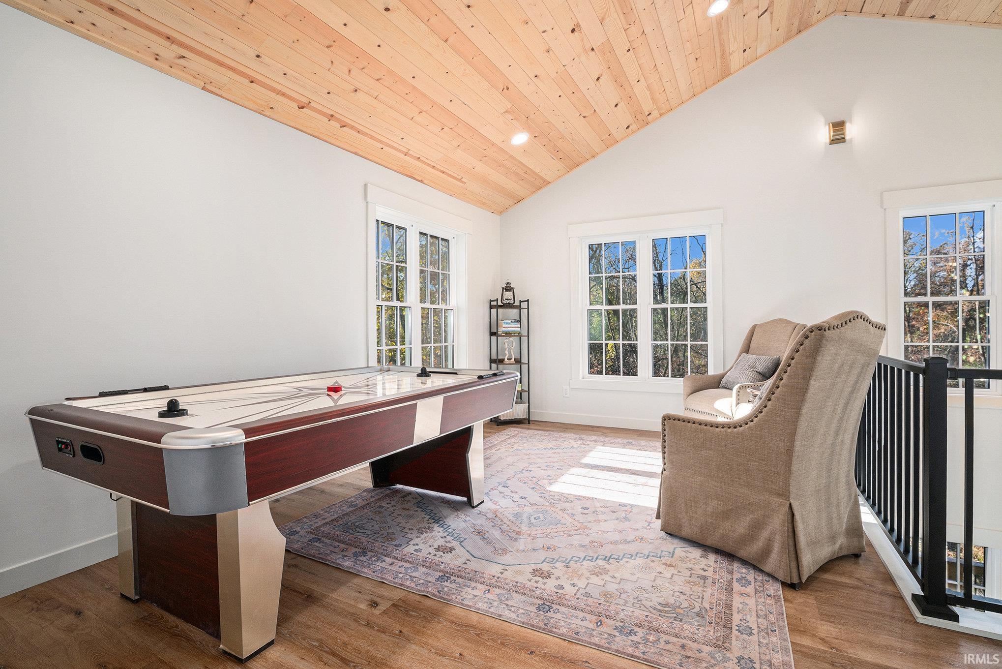 Playroom with recessed lighting, a high wooden ceiling, and light wood-style flooring