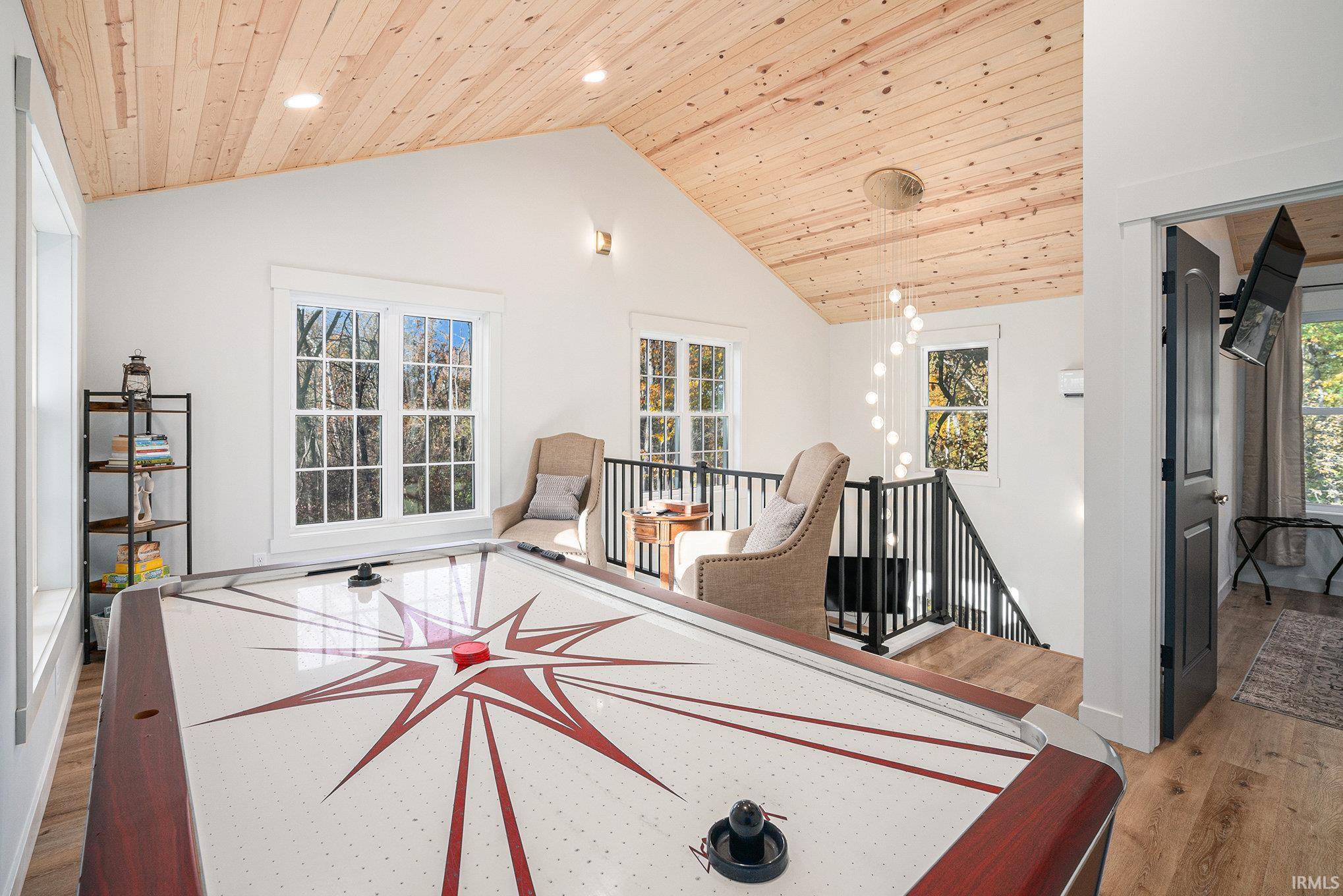 Playroom featuring a vaulted wooden ceiling, light wood-style floors, recessed lighting, and healthy amount of natural light