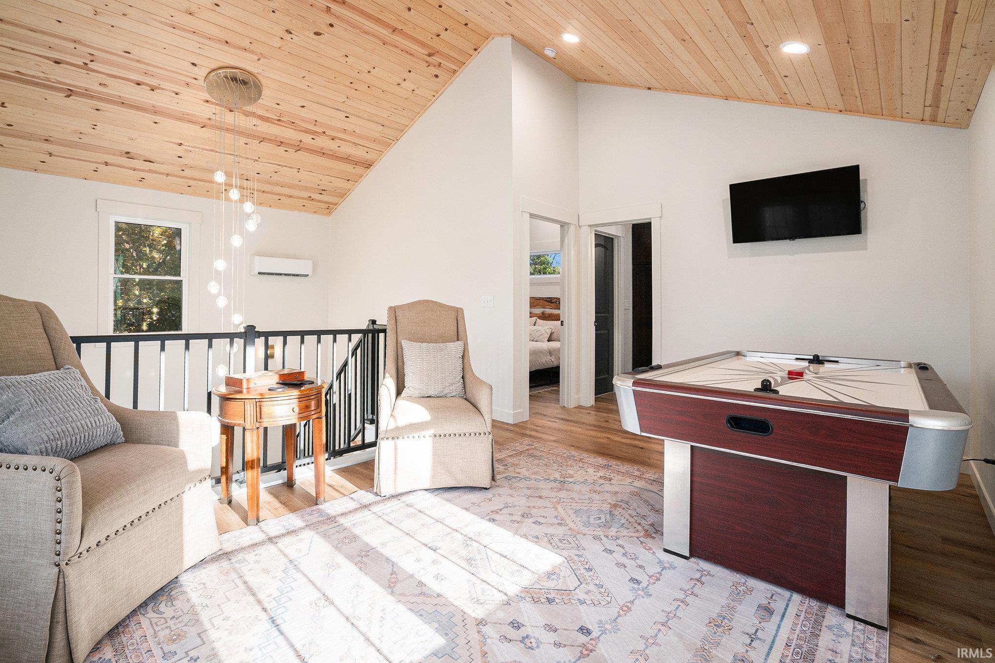 Living area featuring a vaulted wood ceiling, light wood-style floors, and recessed lighting