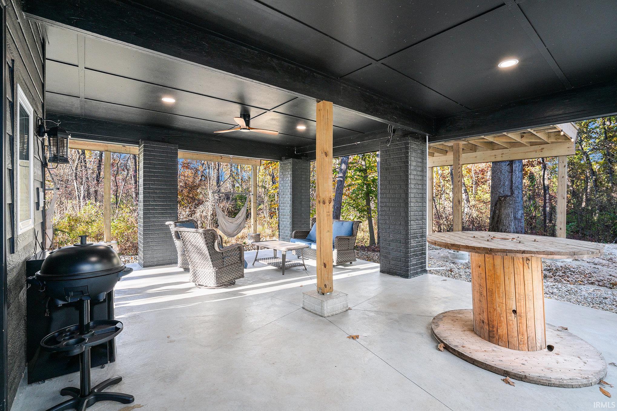 View of patio featuring a ceiling fan, grilling area, and an outdoor lounge area