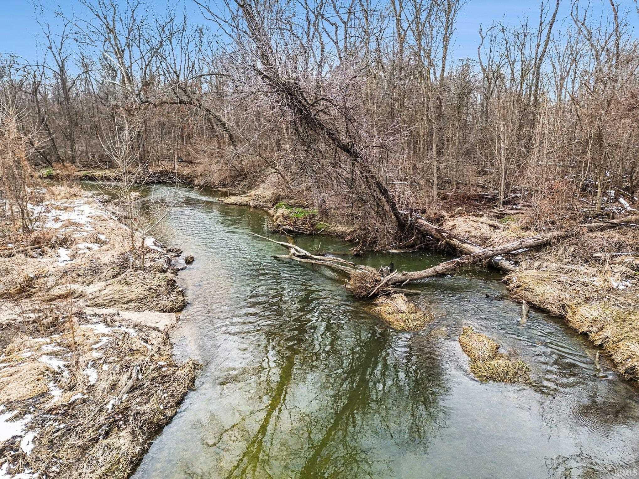 Water view of Baugo Creek featuring a tree filled landscape