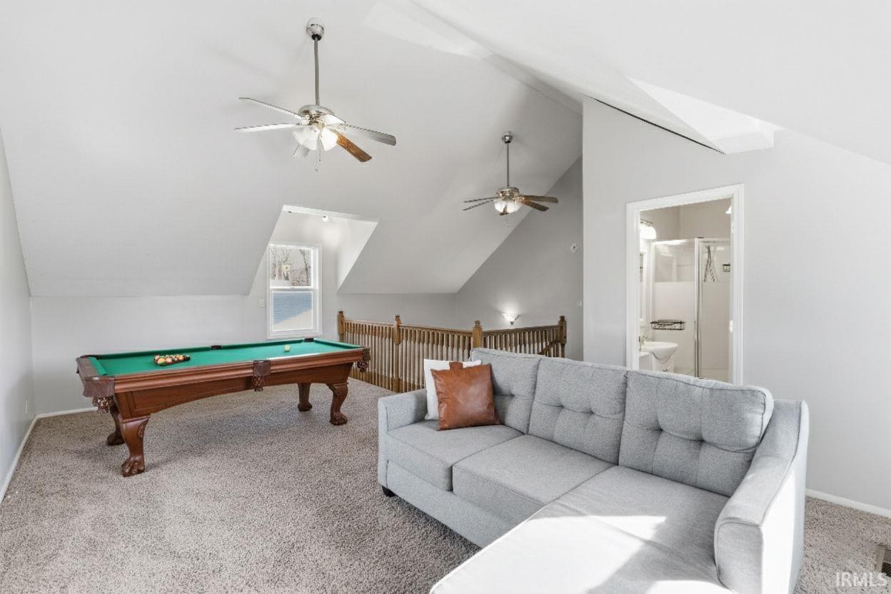 Rec room featuring billiards, carpet, lofted ceiling, and a ceiling fan