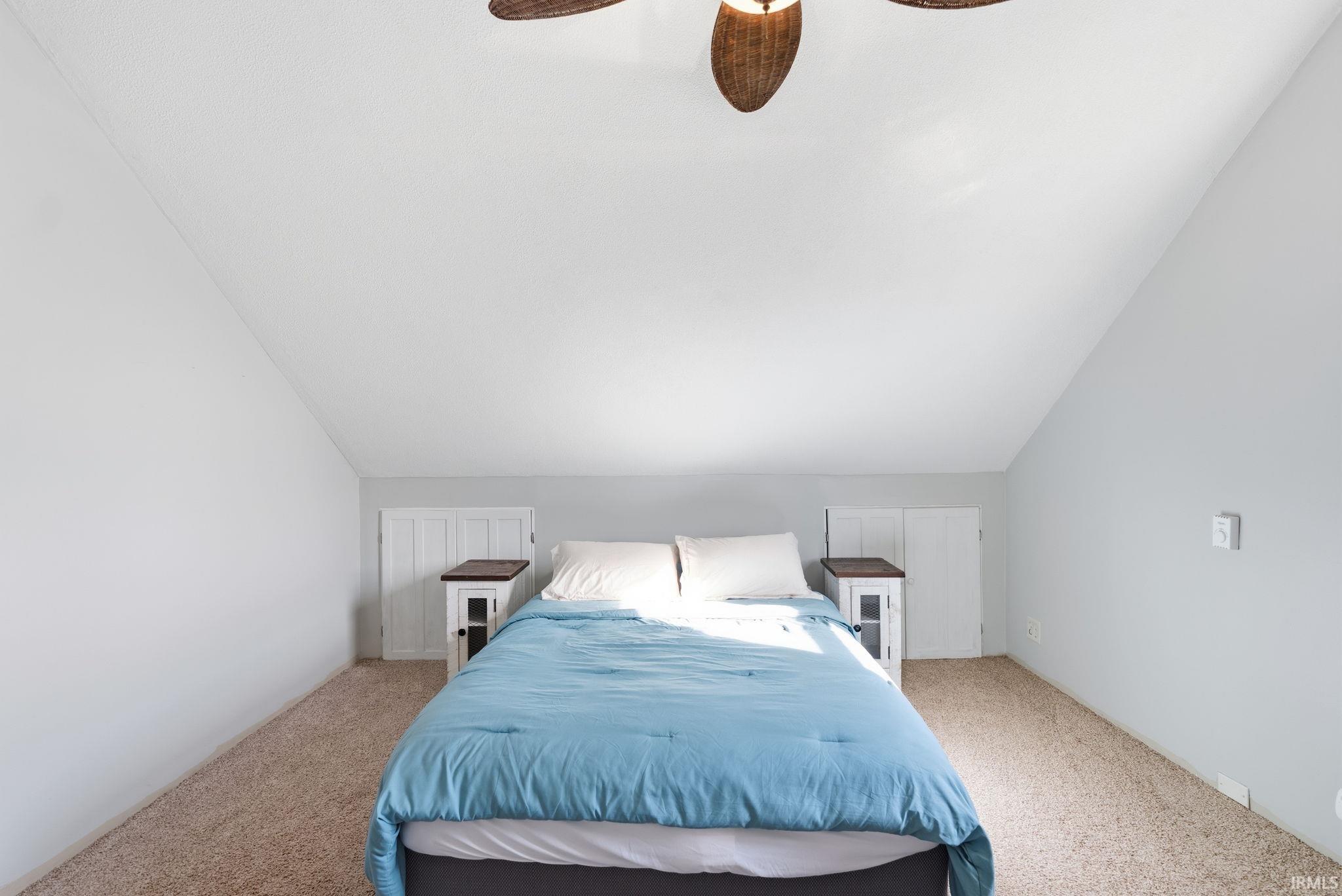 Bedroom with carpet flooring, lofted ceiling, and ceiling fan