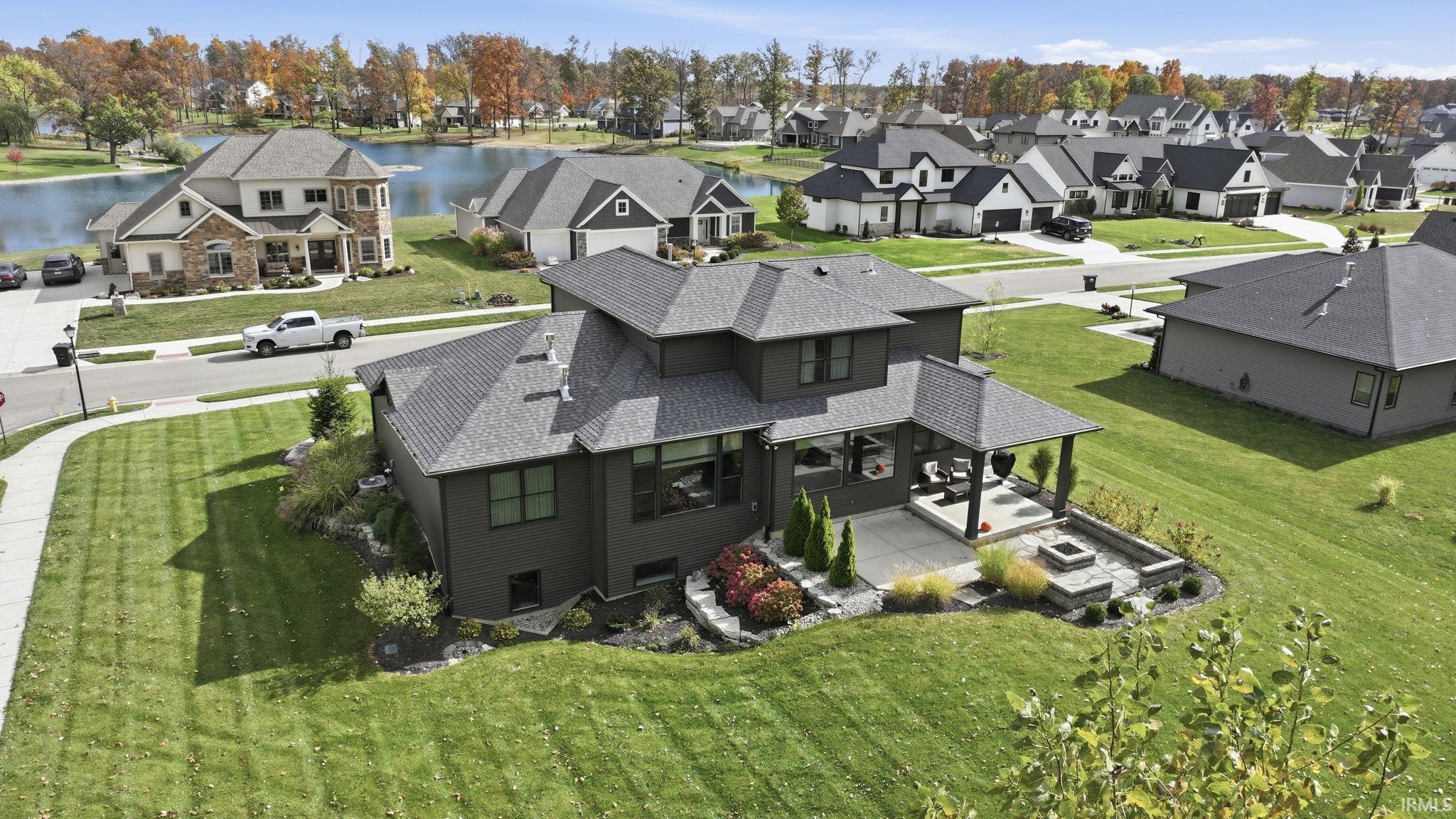 Aerial perspective of suburban area featuring a large body of water