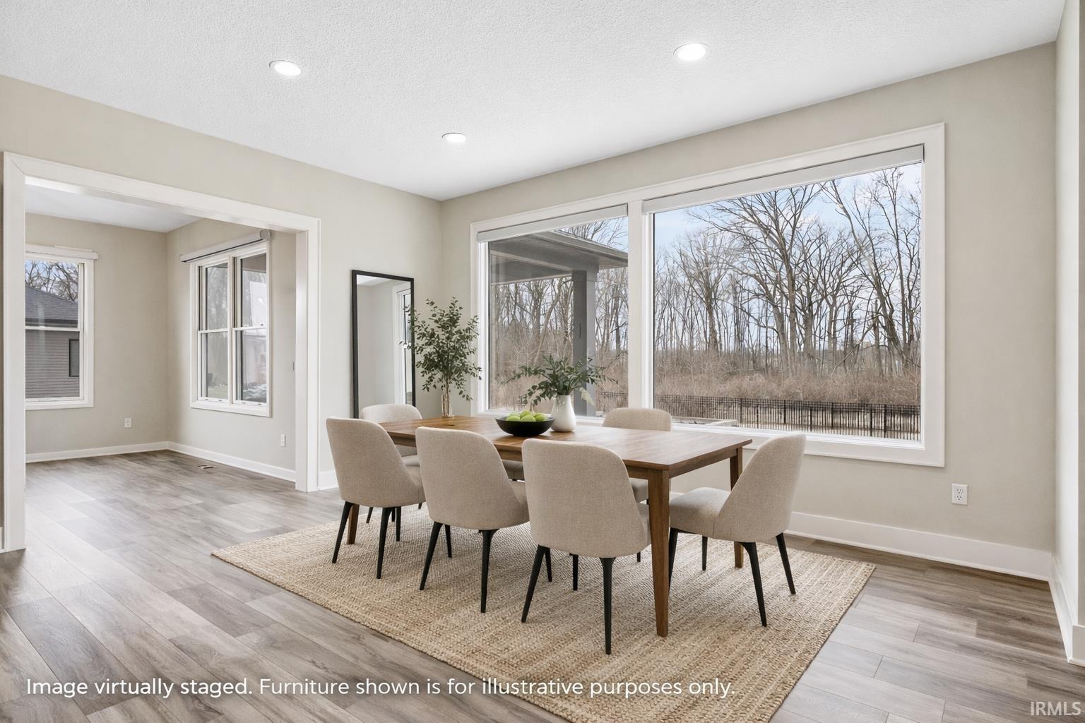 Dining room with light wood-style flooring and recessed lighting