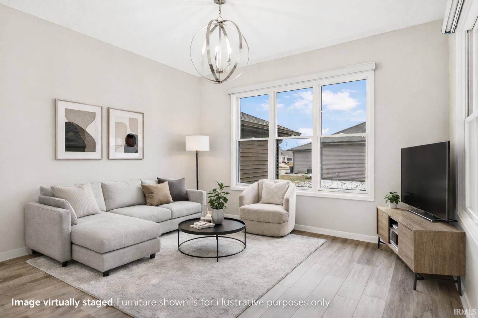 Living room with light wood-style floors and a chandelier