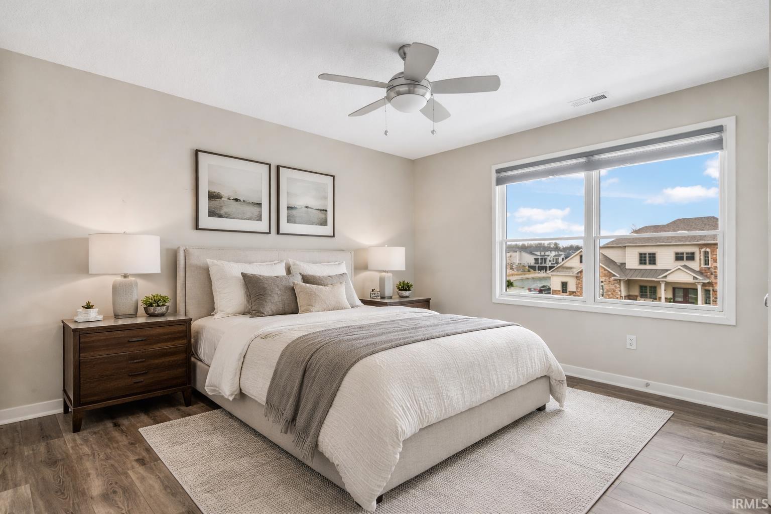 Bedroom featuring a ceiling fan and dark wood-type flooring