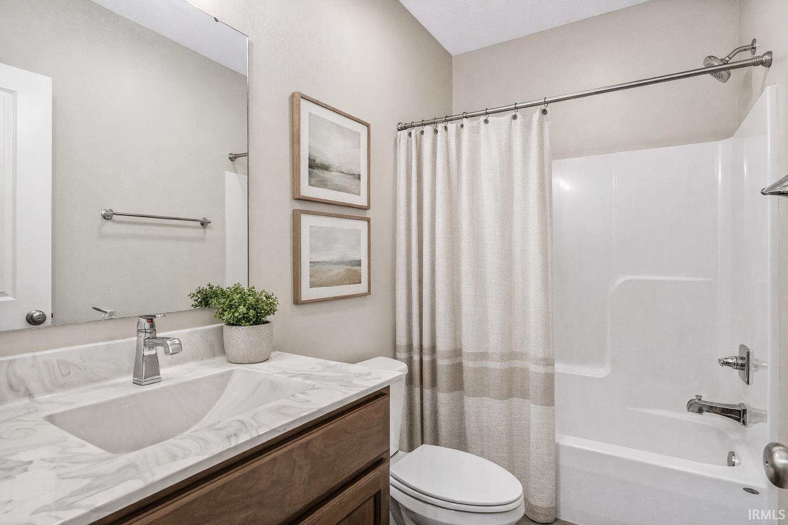 Full bath featuring vanity and shower / tub combo with curtain