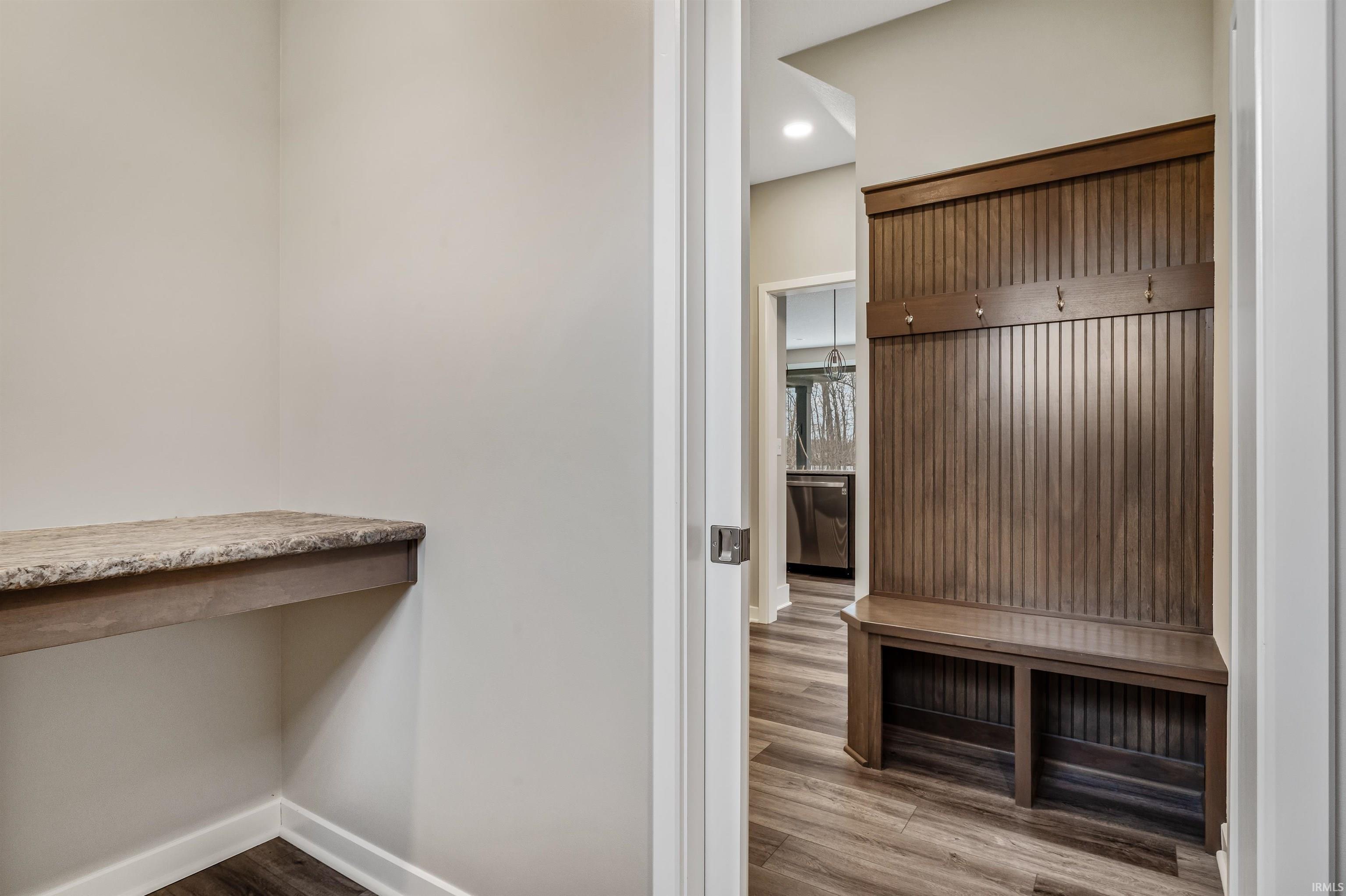 Mudroom featuring dark wood-type flooring and recessed lighting