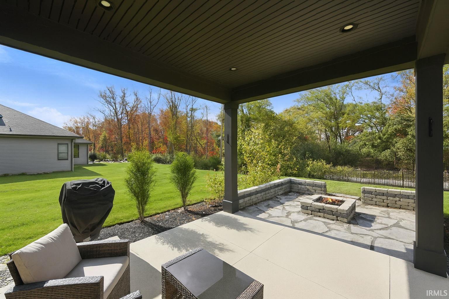 View of patio featuring grilling area and a fire pit