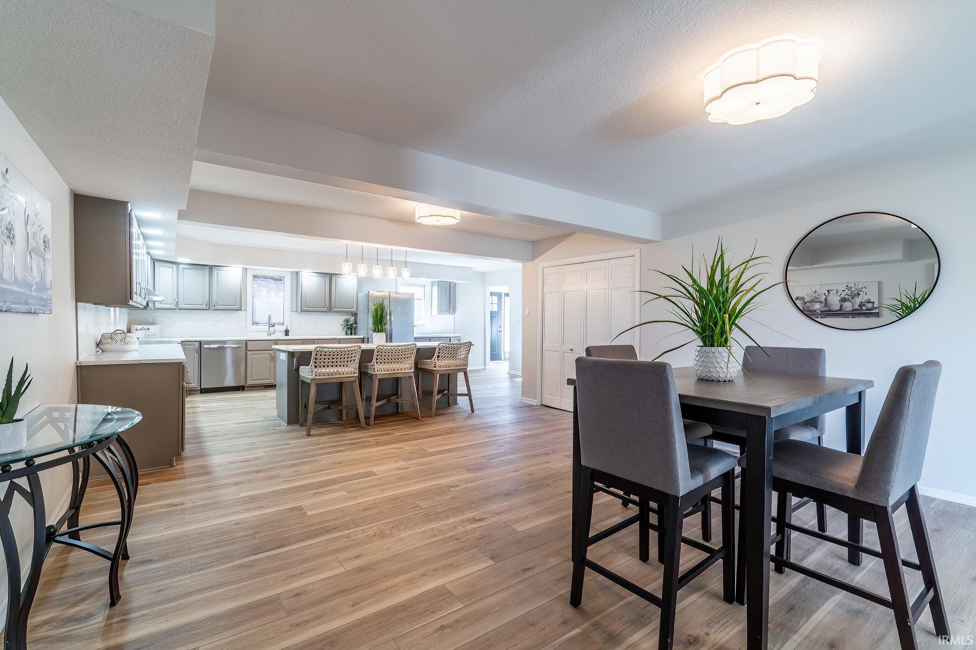Dining space featuring light wood-style floors and a textured ceiling
