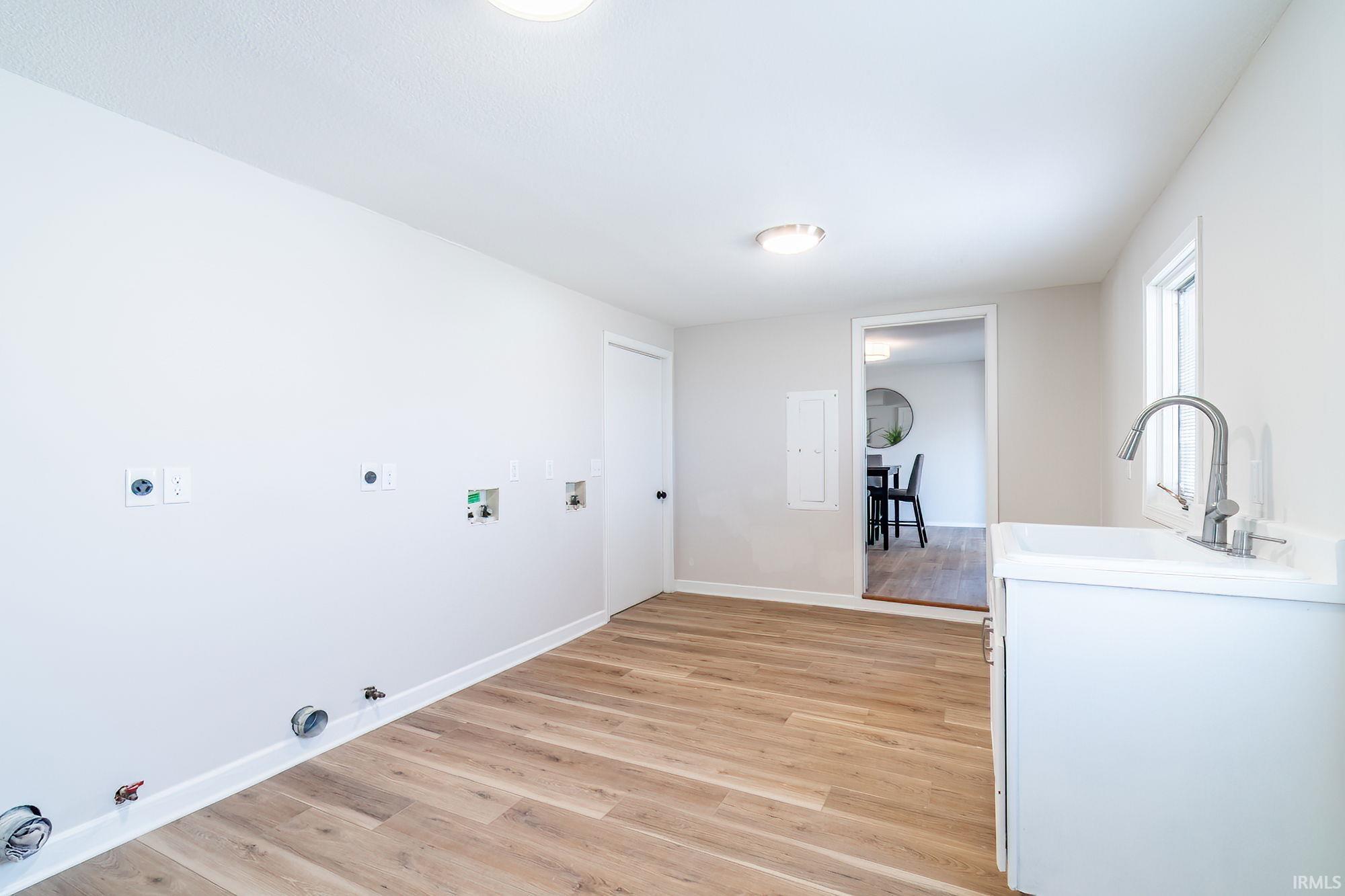Laundry area featuring gas dryer hookup, light wood-type flooring, washer hookup, and hookup for an electric dryer