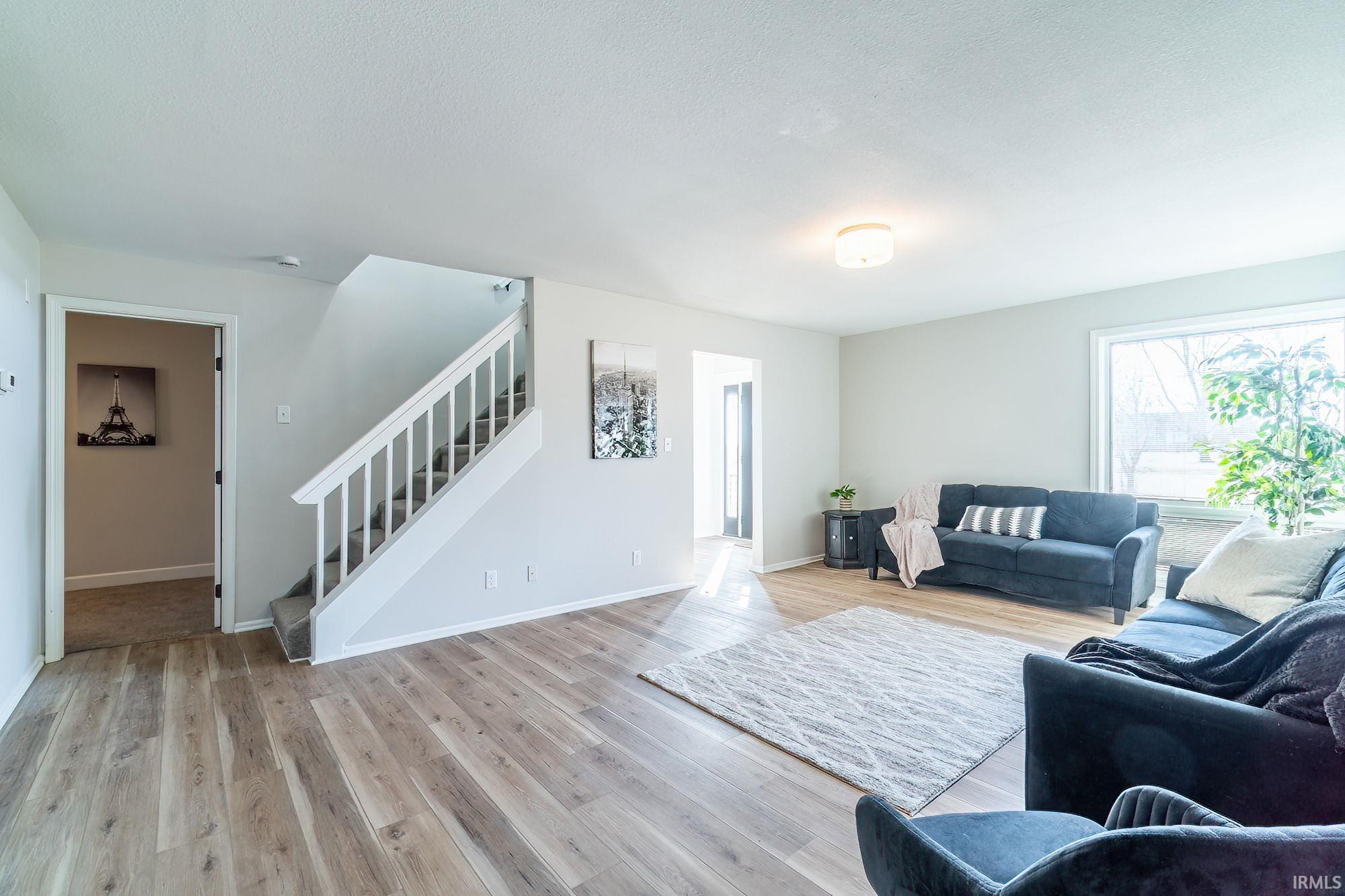 Living room featuring stairway and light wood finished floors