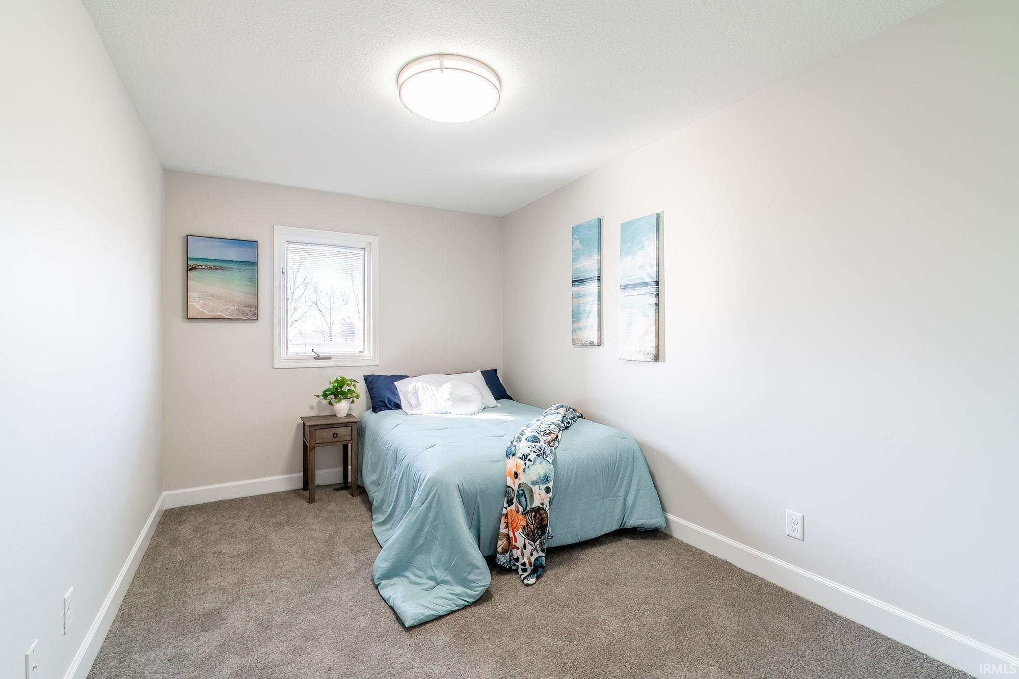 Carpeted bedroom with baseboards
