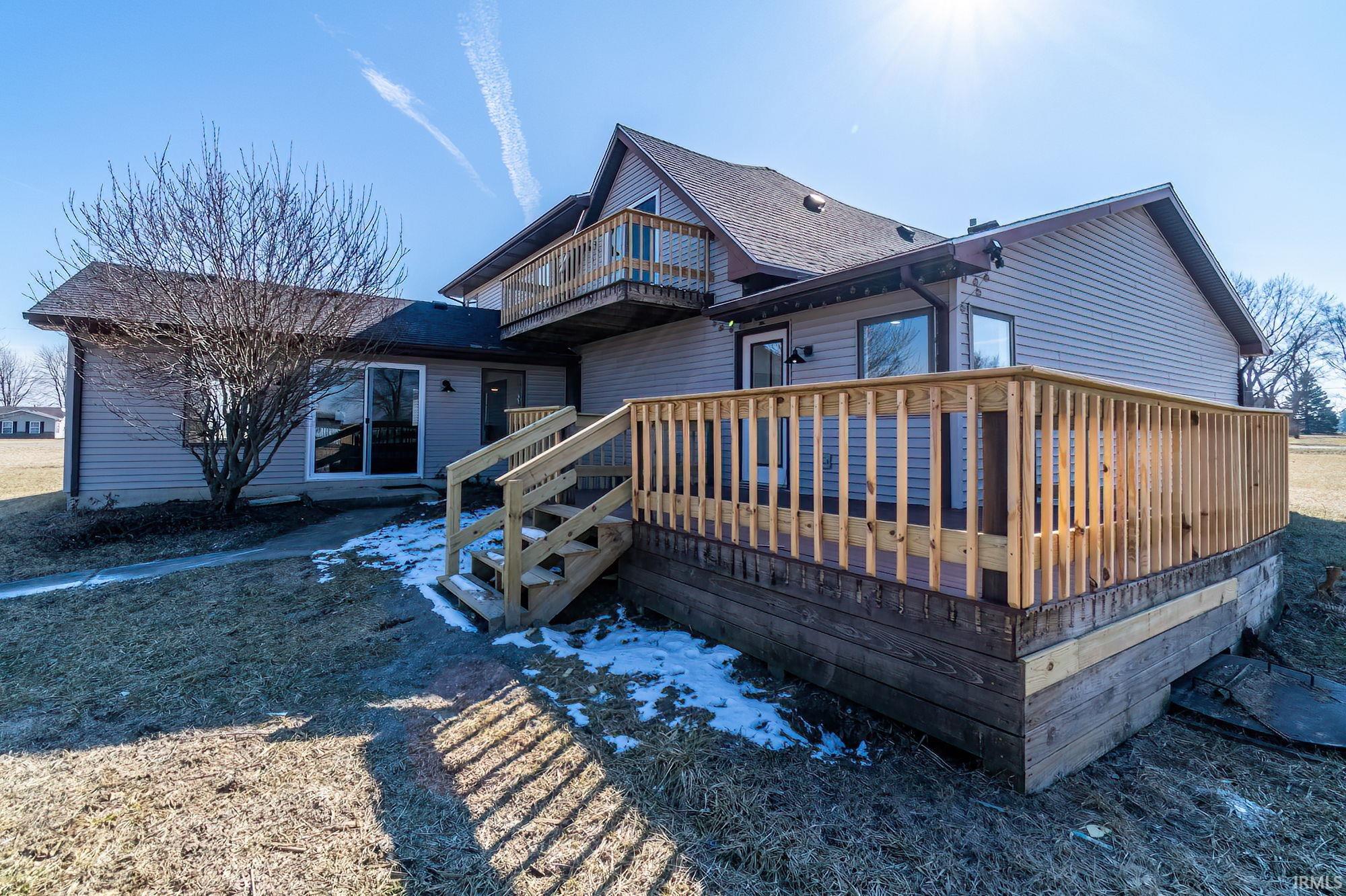 Rear view of property with a wooden deck