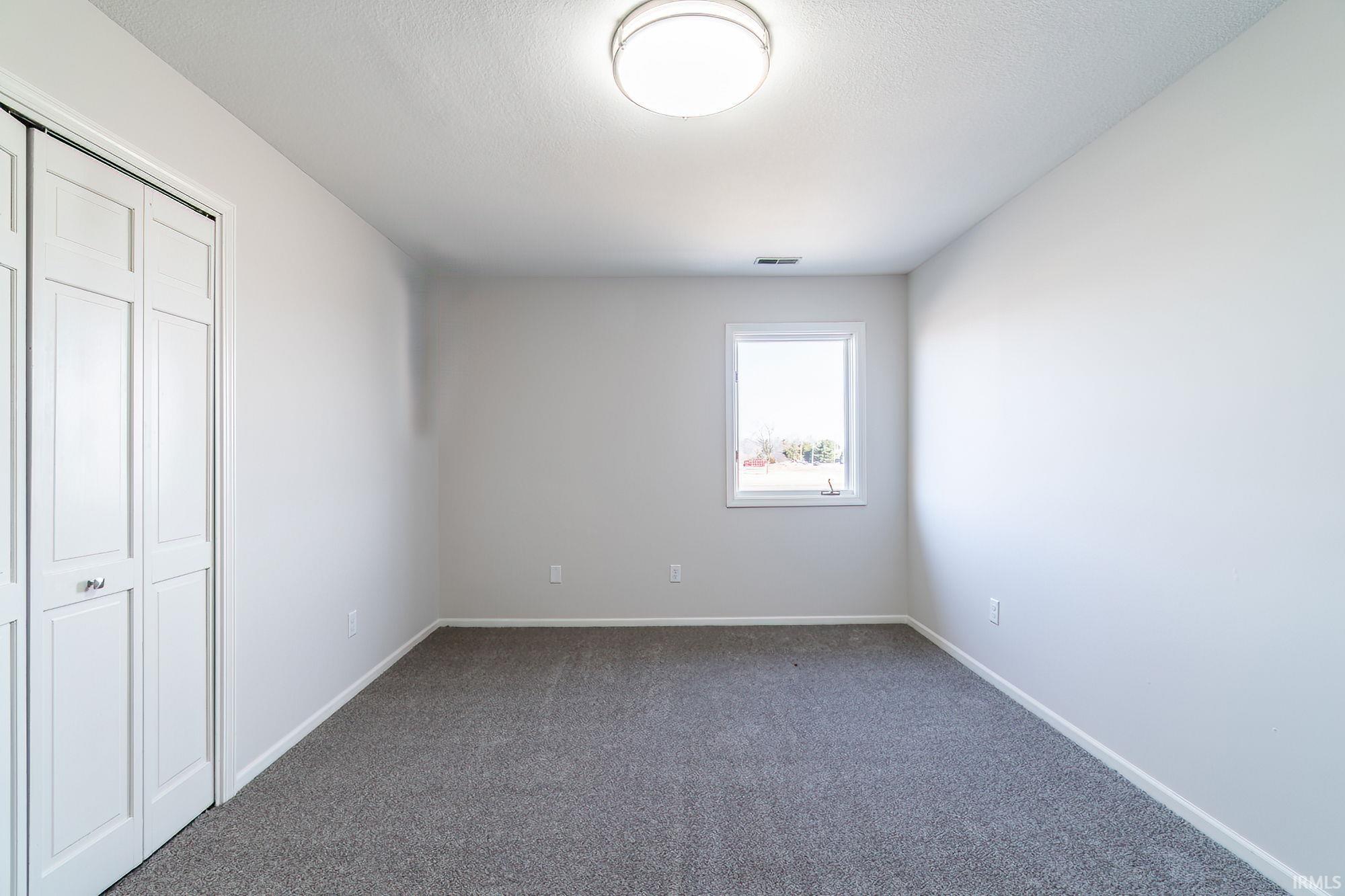Unfurnished bedroom with a closet and carpet