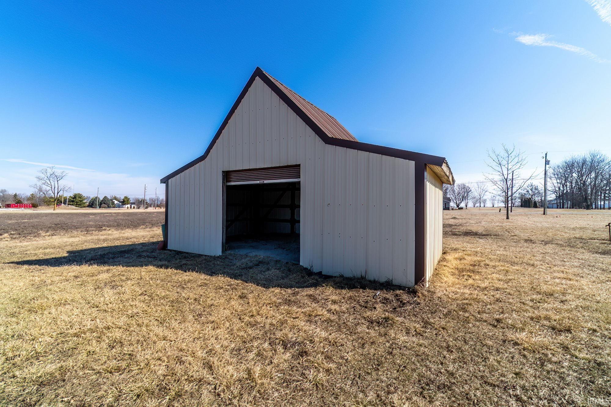 View of pole building featuring a yard