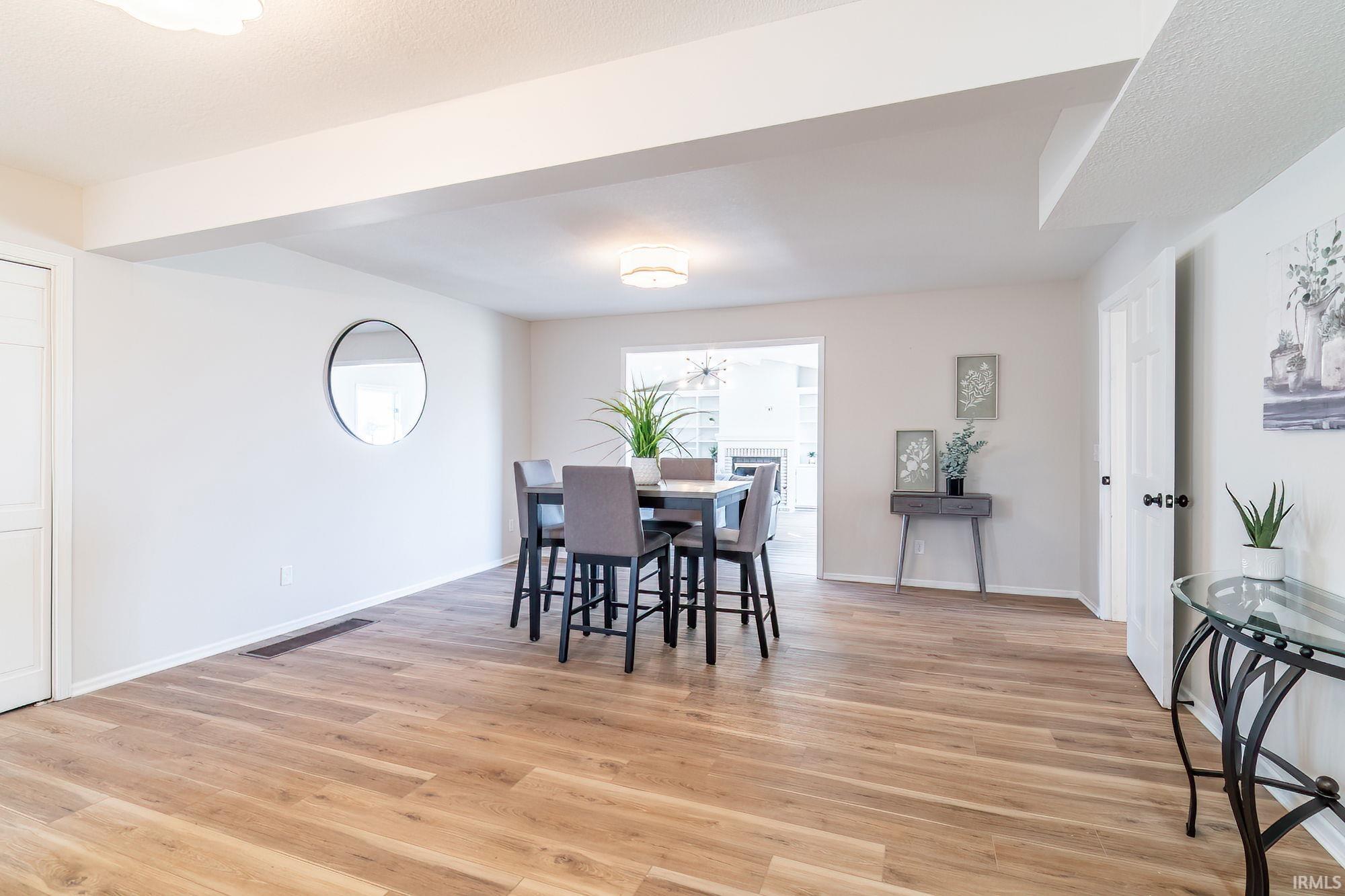 Dining space with light wood-style floors and baseboards