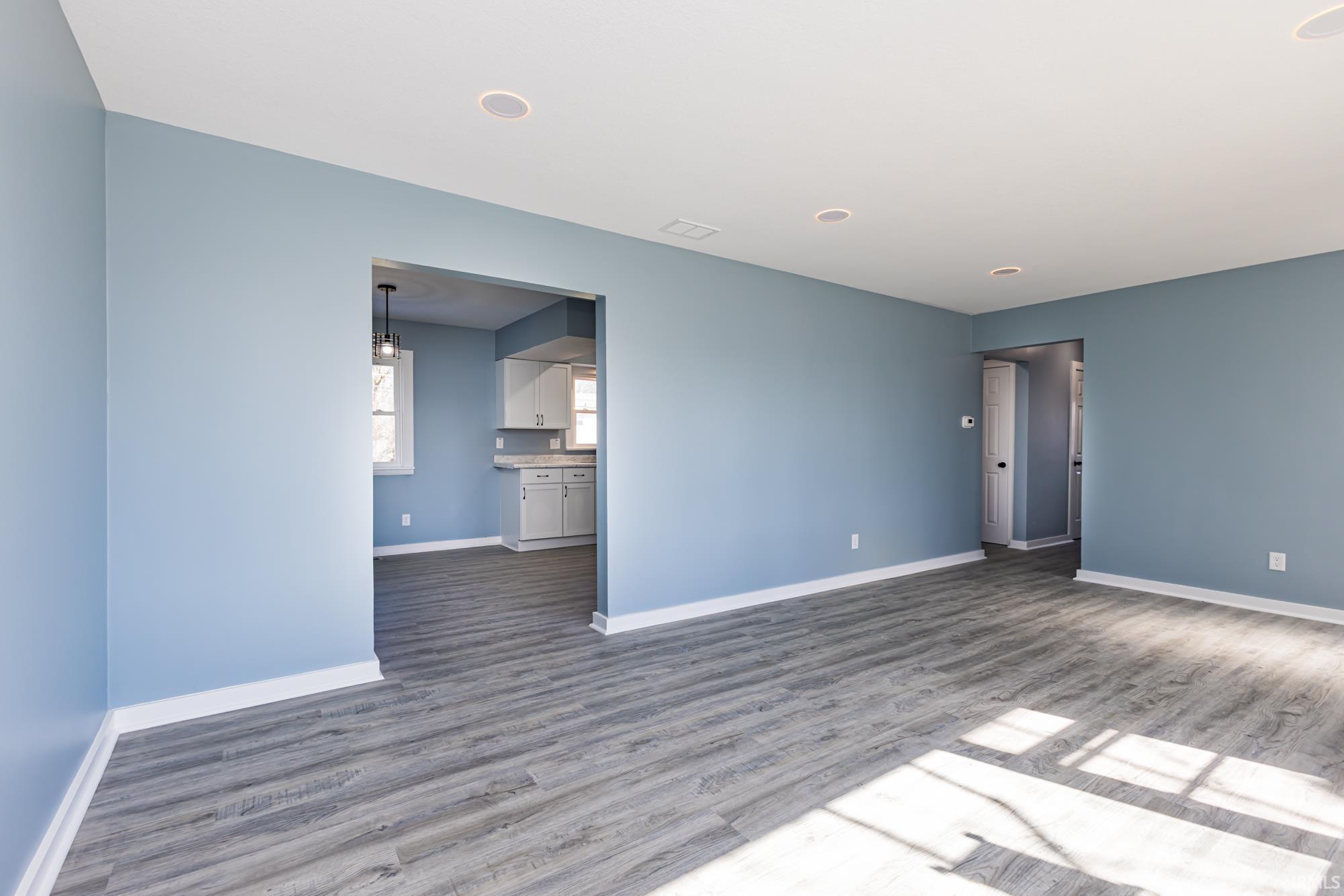 Unfurnished room featuring dark wood-style floors and recessed lighting