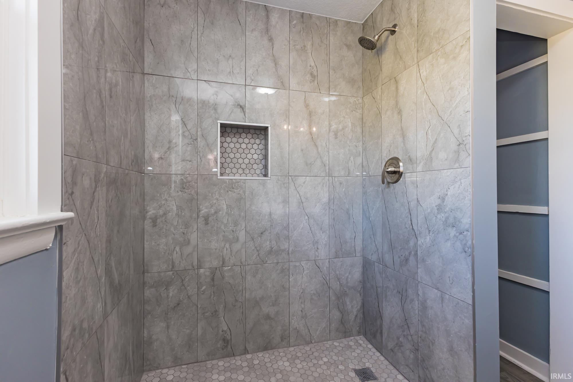 Bathroom featuring a tile shower