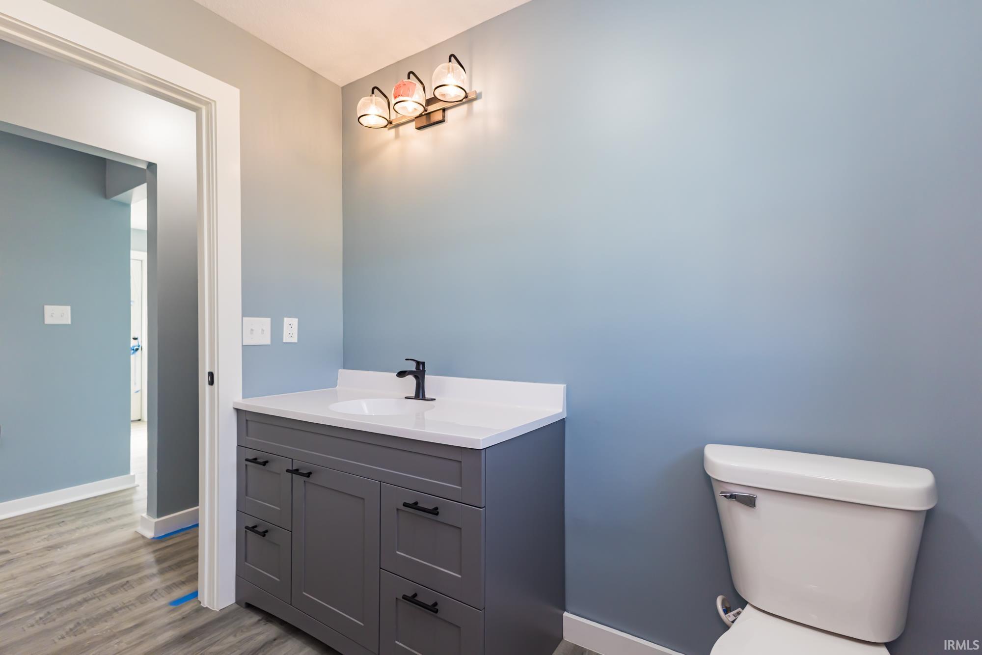 Bathroom featuring vanity and wood finished floors