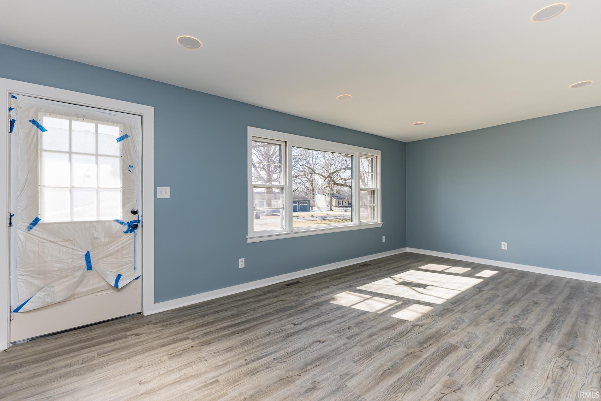 Entryway with plenty of natural light and light wood-style floors