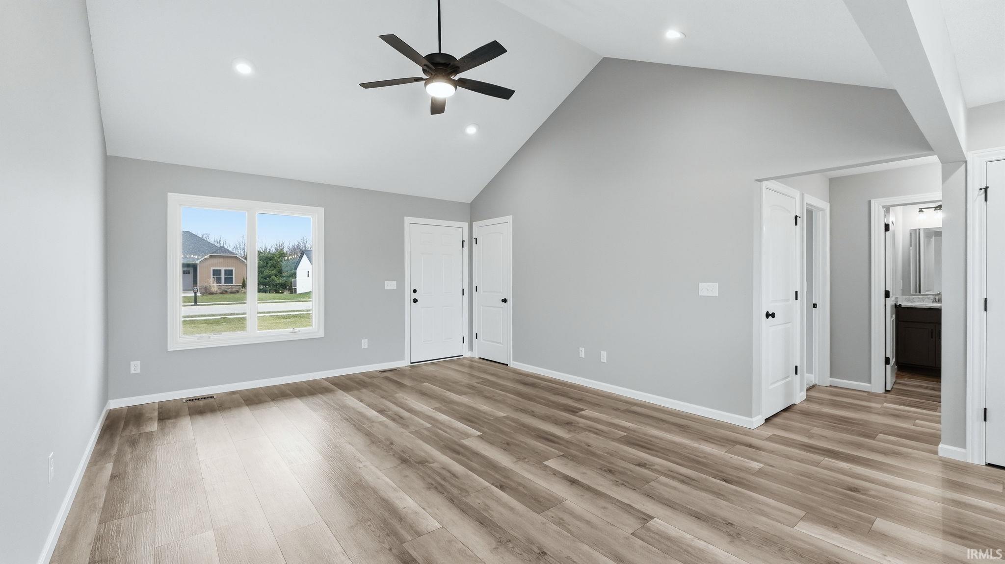 Unfurnished bedroom with a high ceiling, light wood finished floors, recessed lighting, and ceiling fan