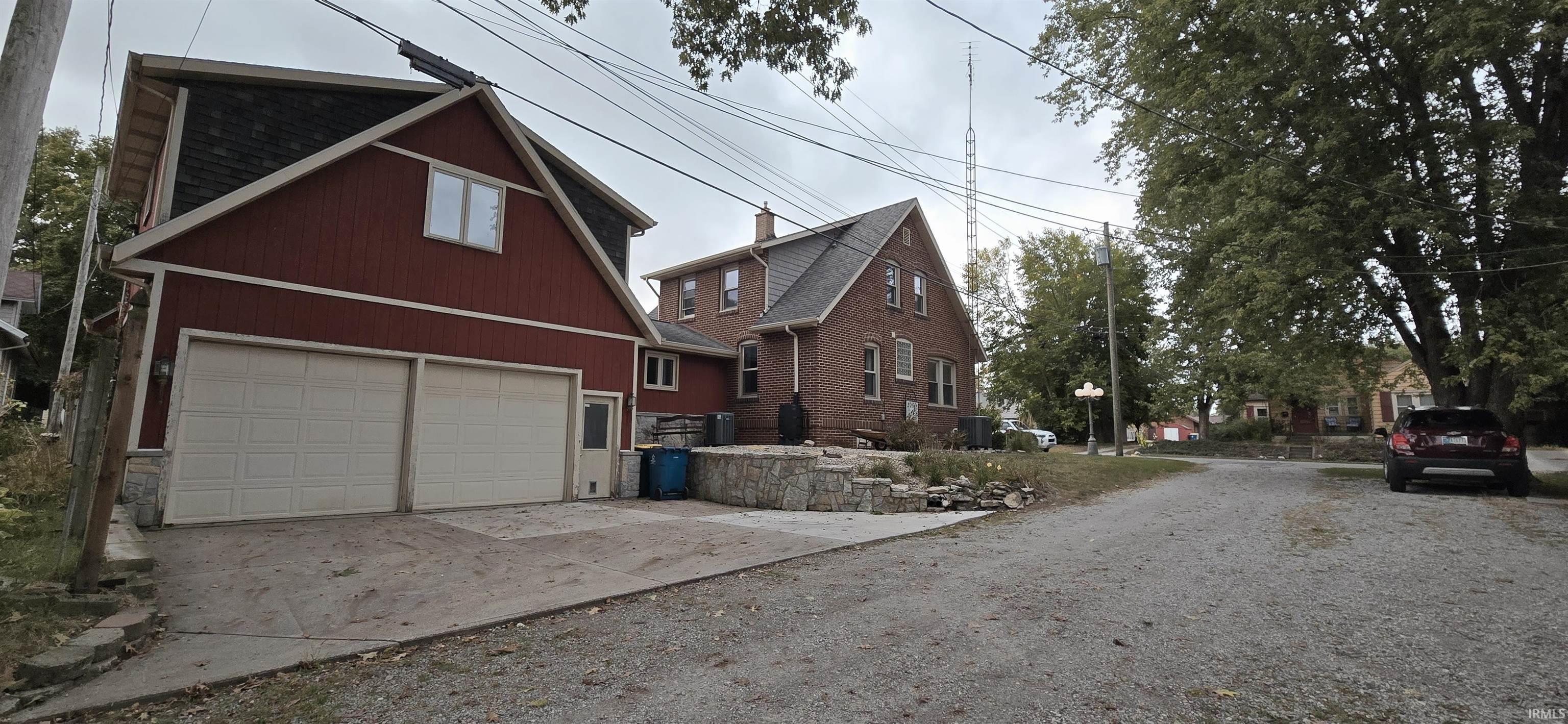 View of property exterior featuring concrete driveway