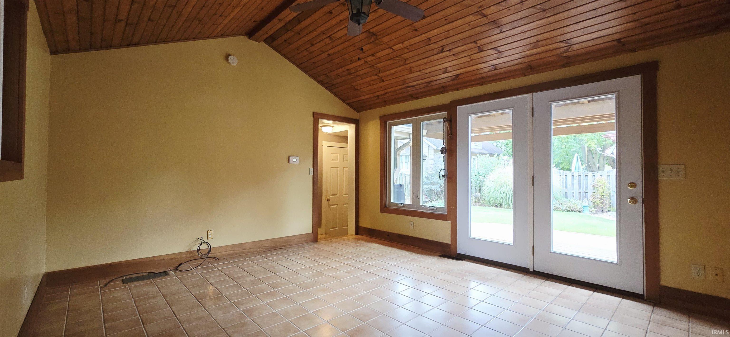 Doorway to outside with ceiling fan and wood ceiling