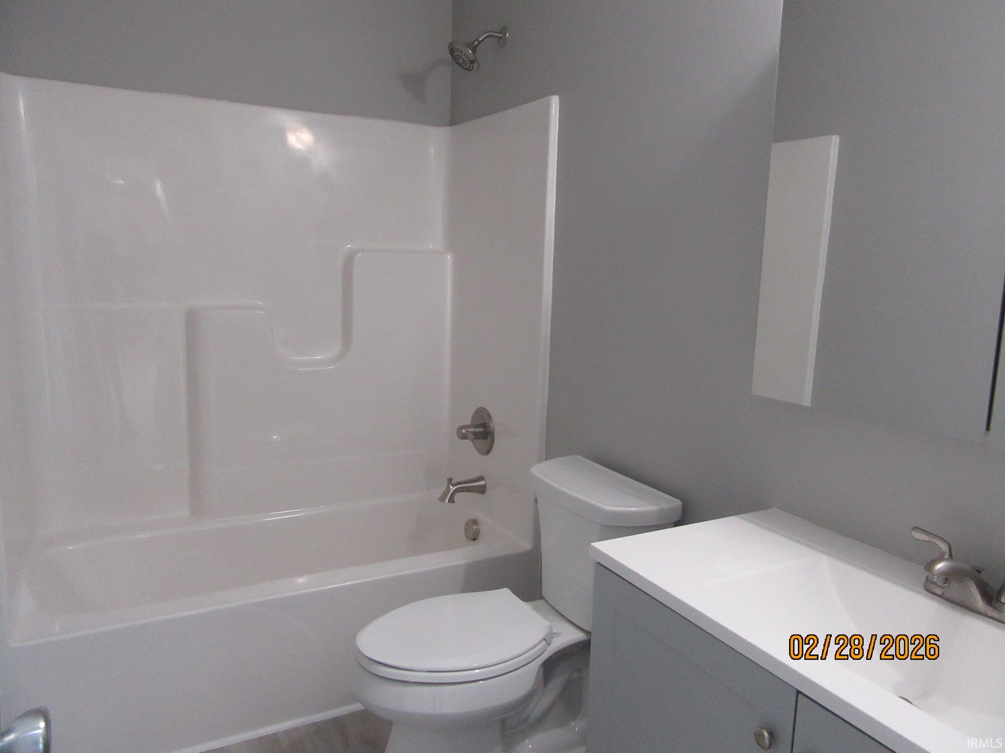 Full bath with vanity and shower / washtub combination