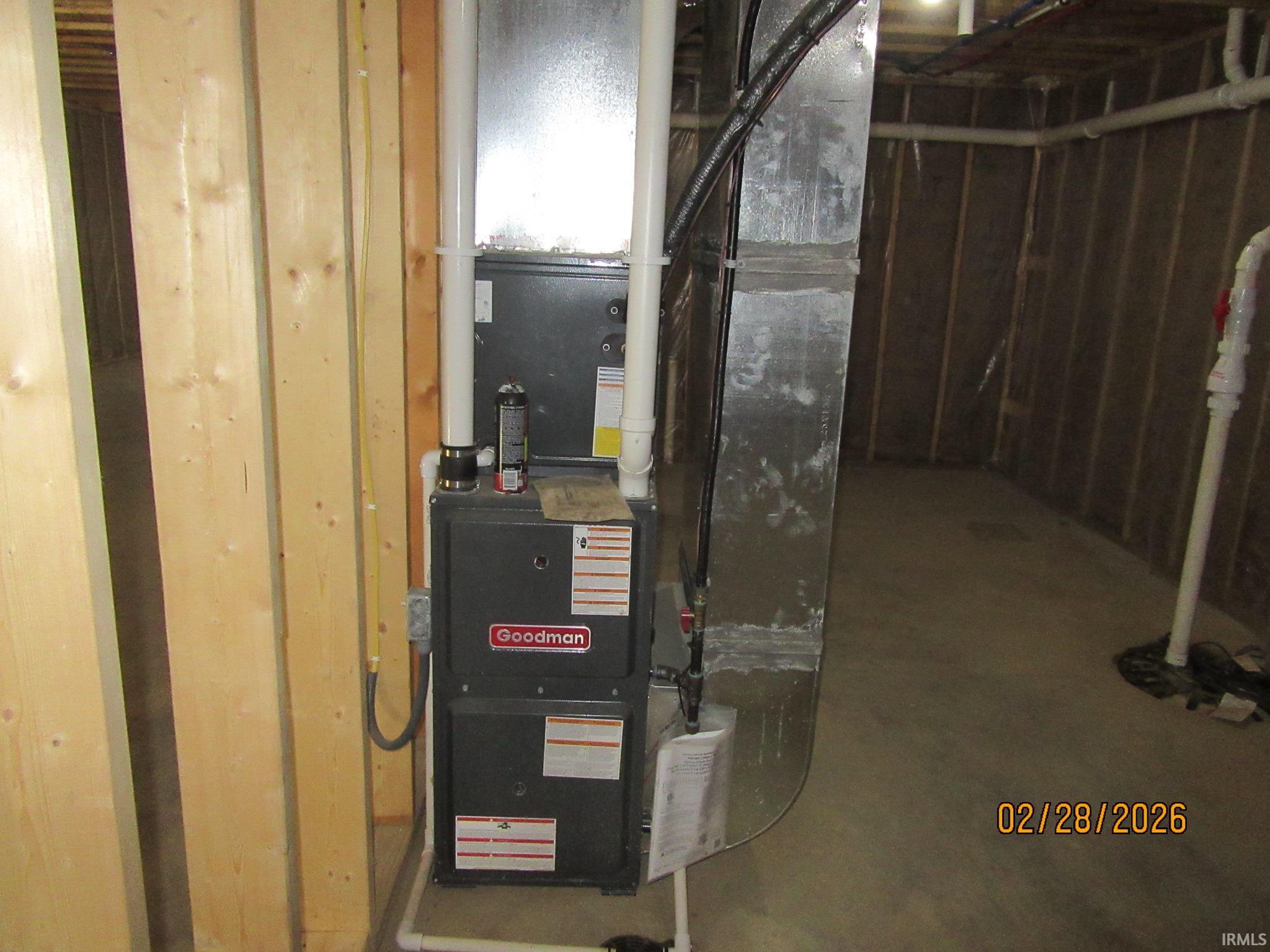 Utility room featuring heating unit and drainage system