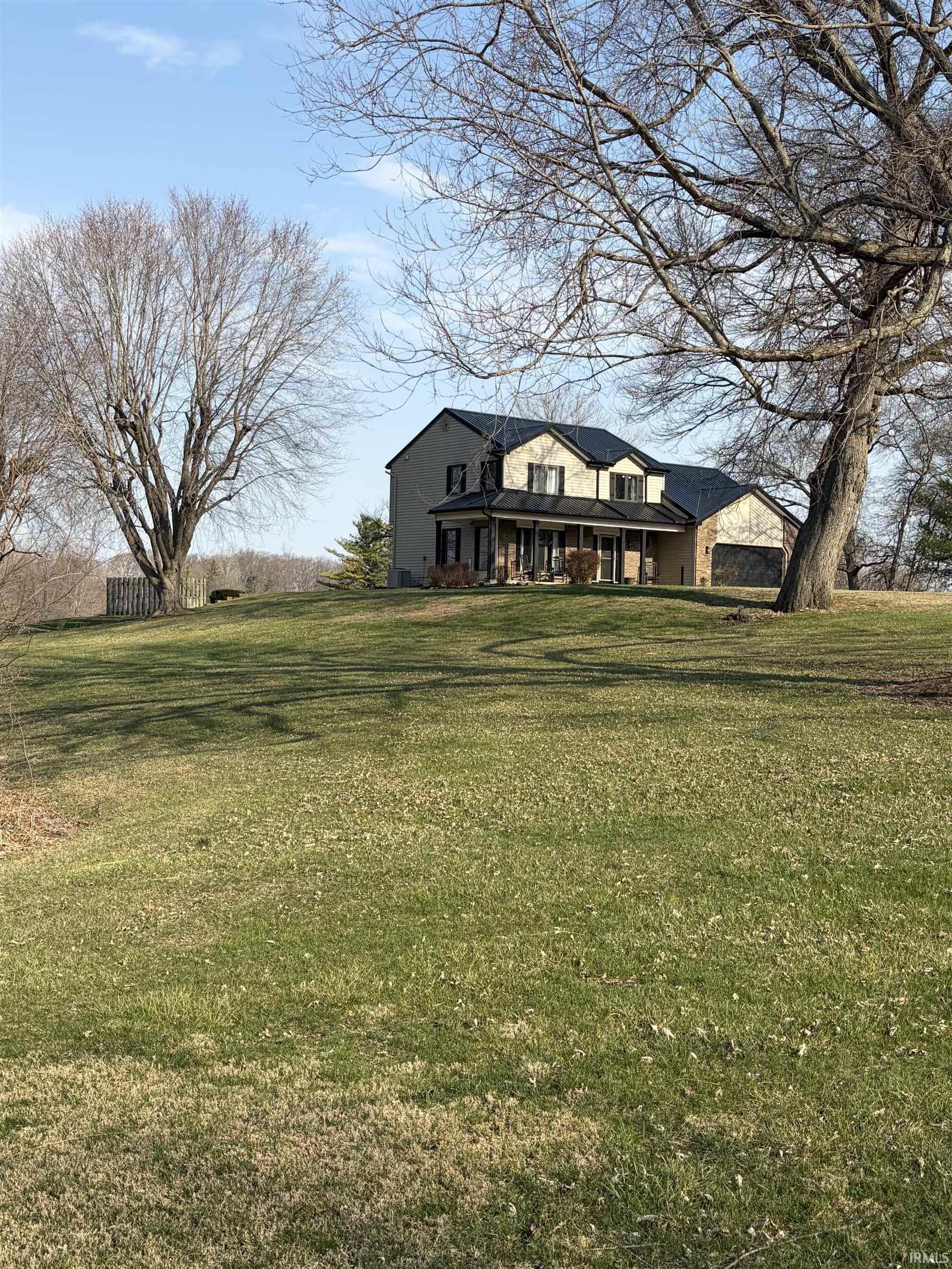View of front of house with a porch and a front lawn
