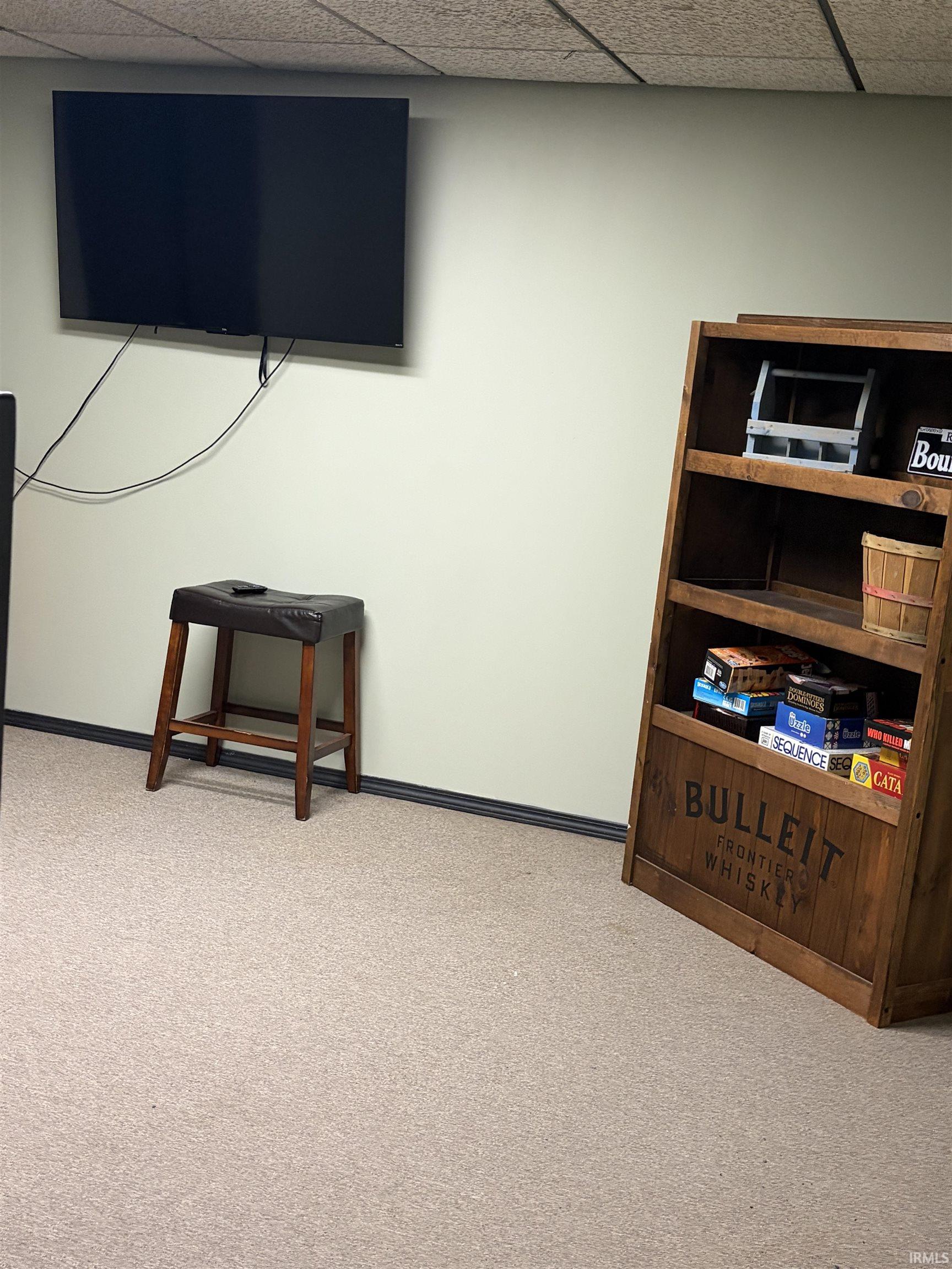 Detailed view of a drop ceiling and carpet flooring