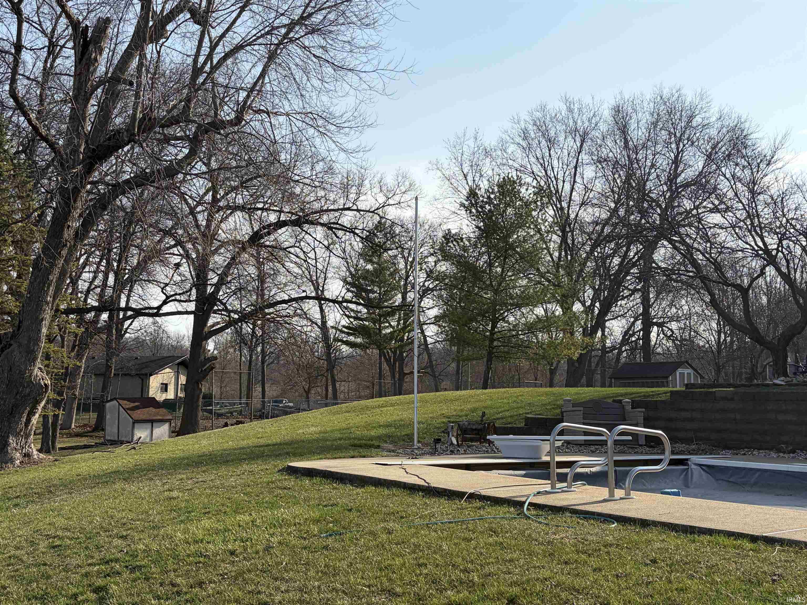 View of green lawn featuring a shed, a patio, and a covered pool