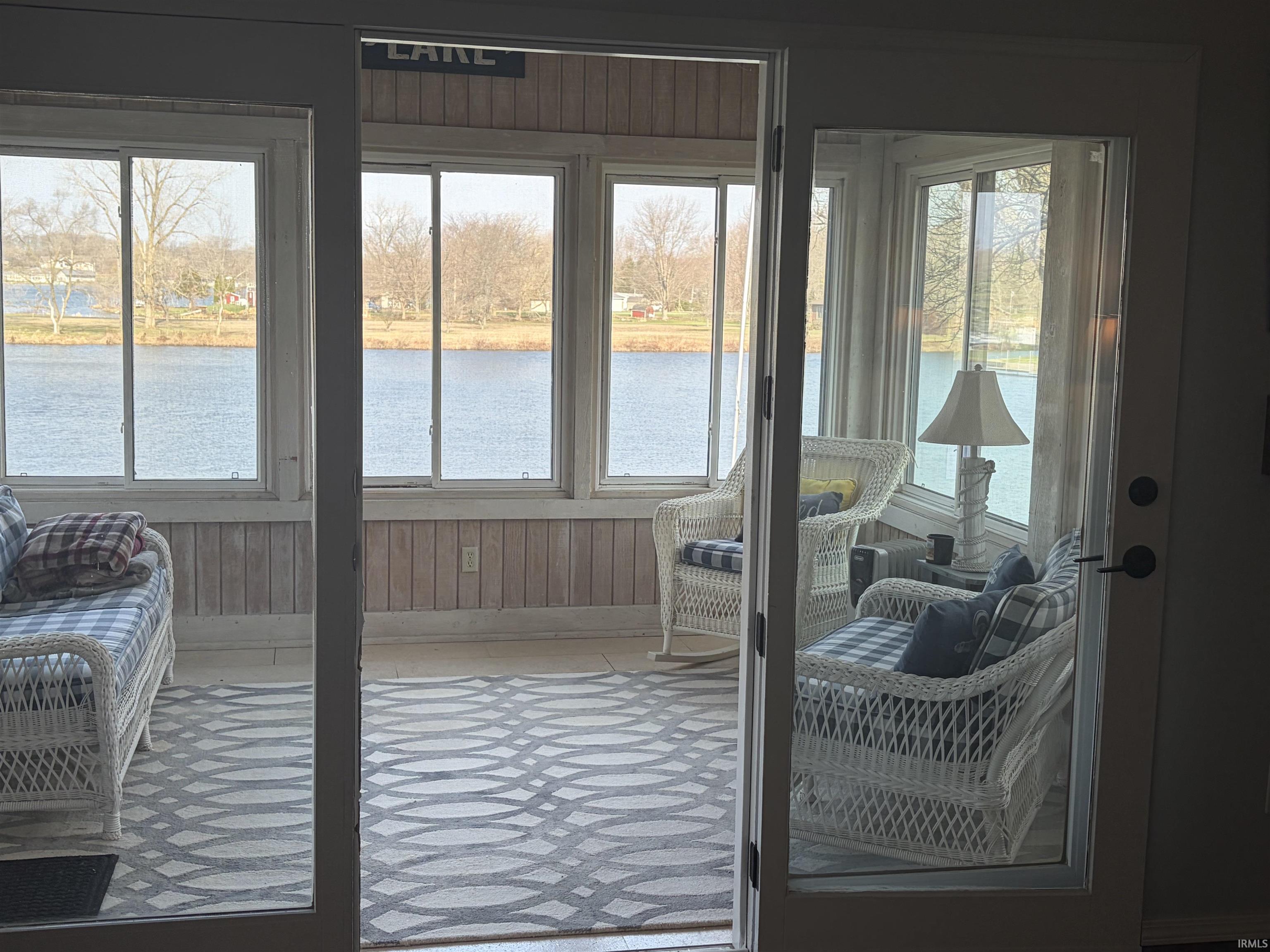 Entryway with a water view and baseboards