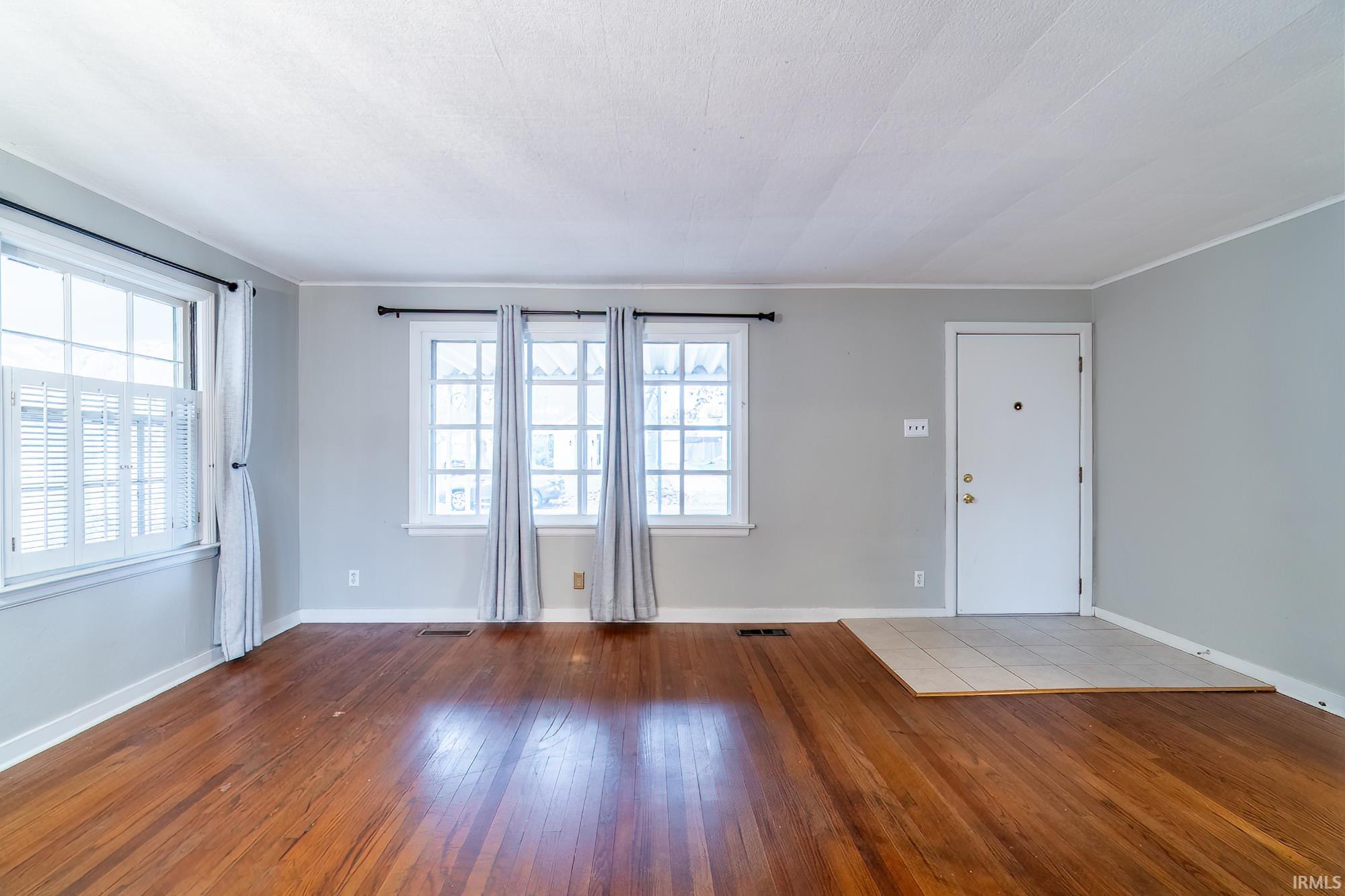 Spare room with light wood finished floors and healthy amount of natural light