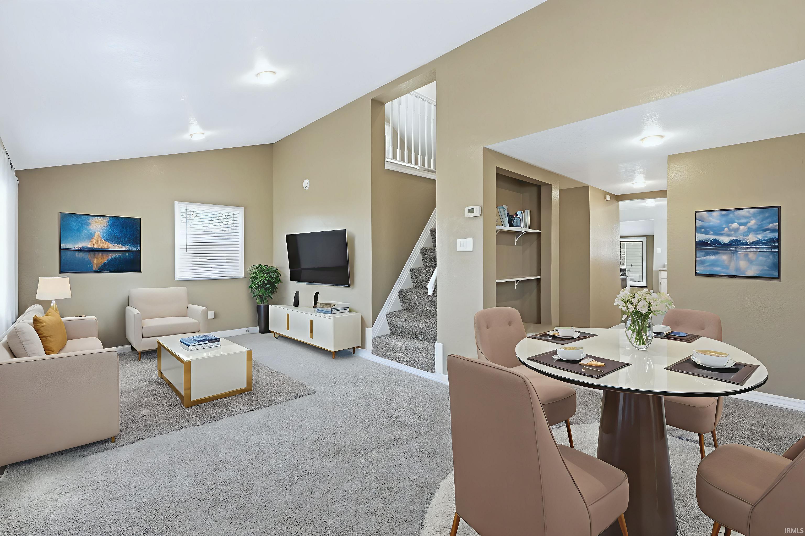 Carpeted dining area with built in features and lofted ceiling