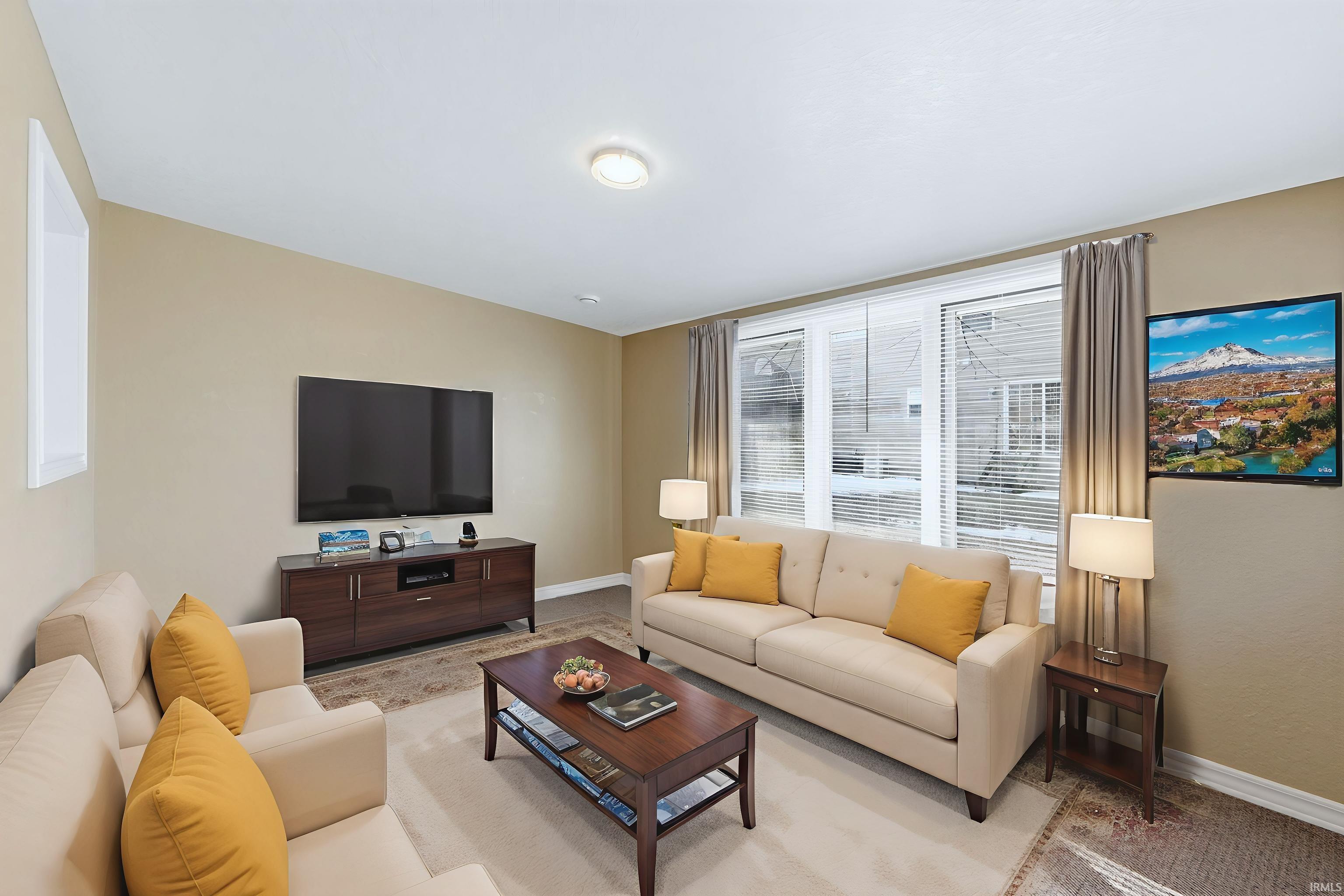 Living room featuring baseboards and light carpet