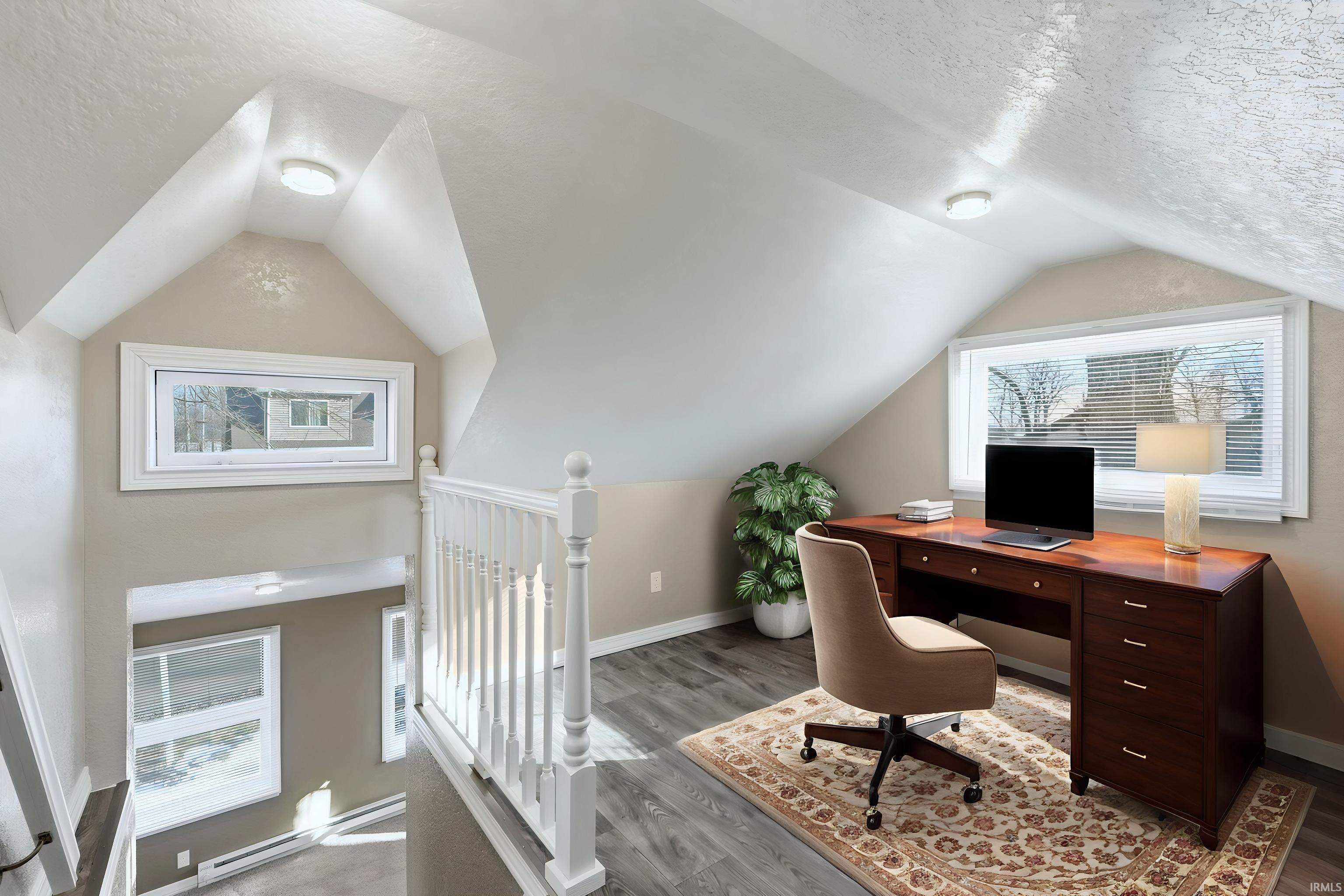 Home office featuring a textured ceiling, baseboard heating, and wood finished floors