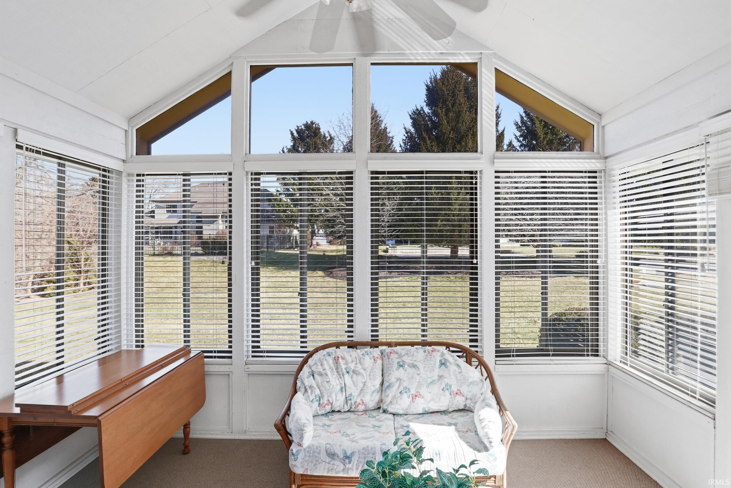Sunroom with carpet flooring and plenty of natural light