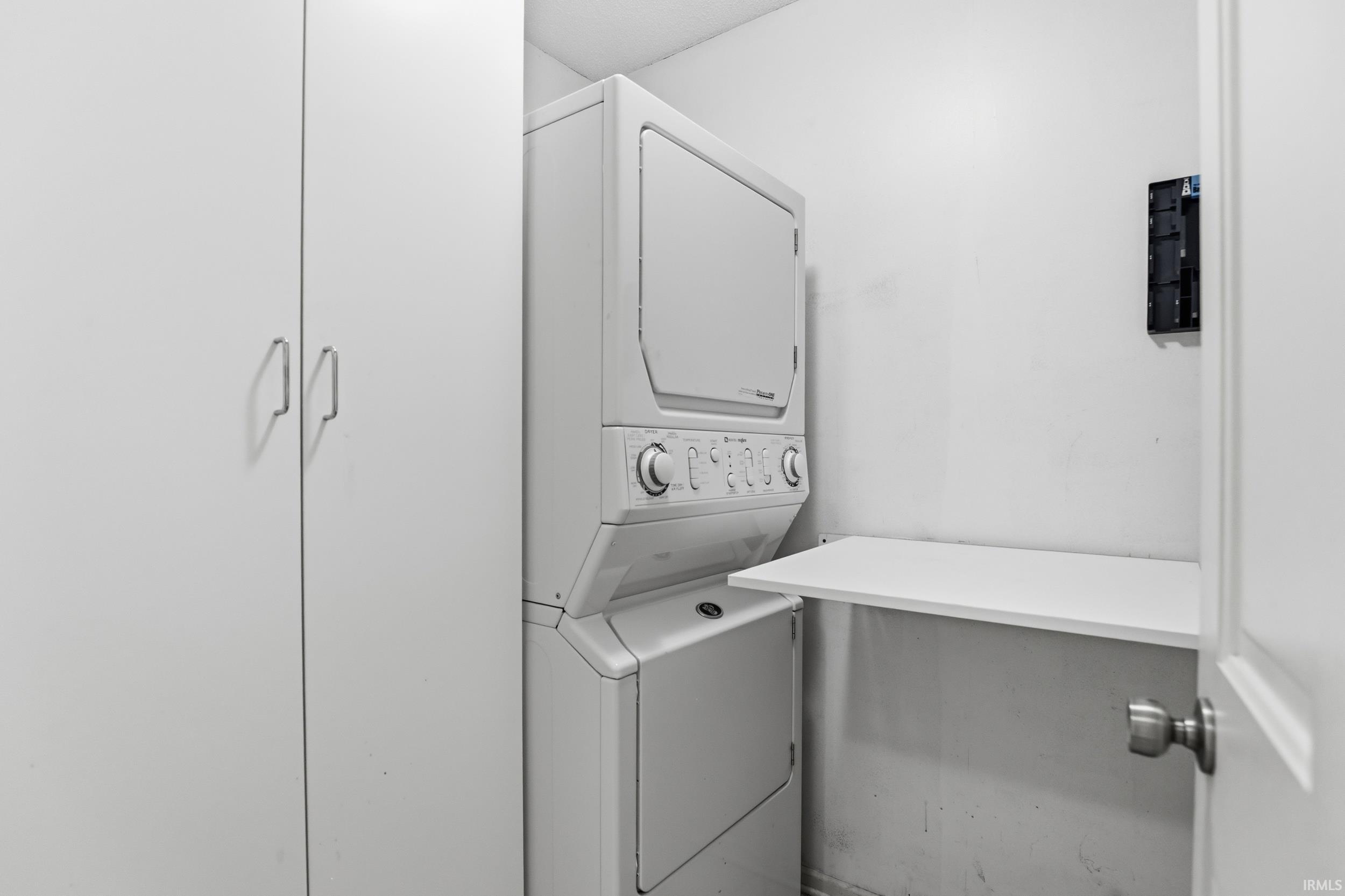 Laundry area featuring stacked washer and dryer